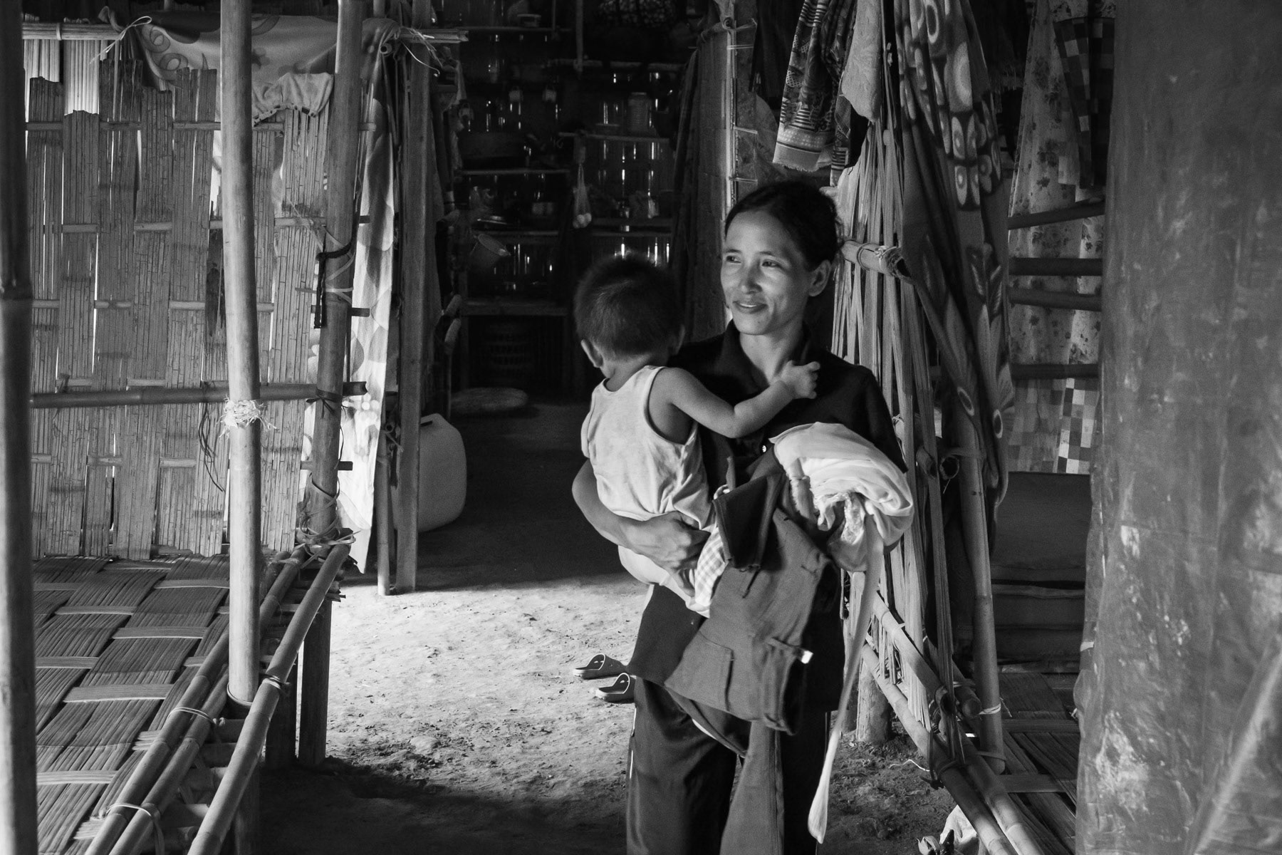 Chin mother and her child who have arrived recently from Myanmar. Refugee camp,in Mizoram, India, October 2022