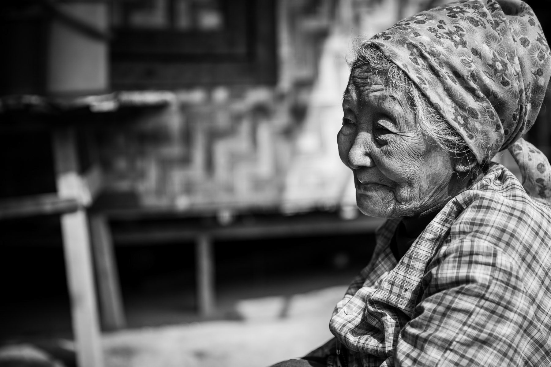 An elderly woman in a camp for internally displaced persons in Kachin State. There are more than 130 IDP camps througout Kachin State, hosting over 100,000 displaced persons. KBC Compound IDP camp in Momauk, Myanmar, Myanmar, January 2020