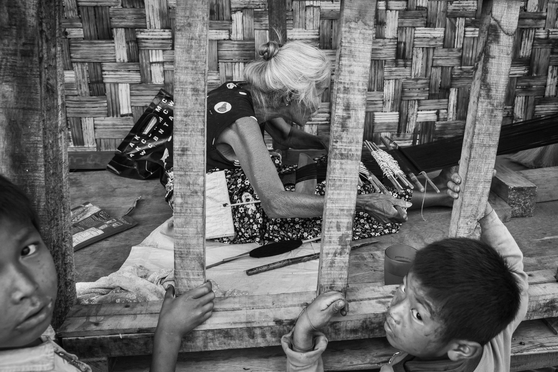 An elderly Kachin woman weaving in Hpun Lum Yang IDP camp along the Chinese border in Kachin Independence Army controlled territory has 3650 residents coming originally from areas that are now on and in between the frontline. KIA controlled territory in Kachin State, Myanmar, April 2019