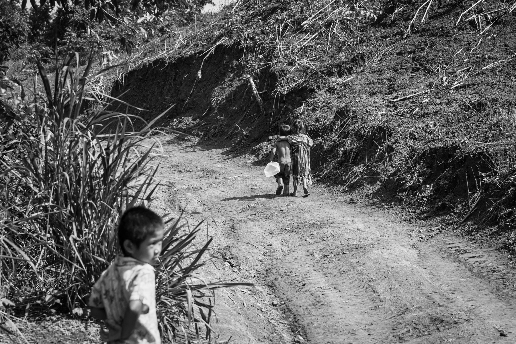 Karen children in a camp near the Thai border in territory controlled by the Karen National Liberation Army (KNLA). They have fled their villages after repeated air attacks by the Myanmar military. Widwspread terror and attacks against civilians and ethnic minorities have substantially increased since the military coup in 2021, provoking large numbers of displaced persons and refugees. Kanele IDP camp, Way Lay, Kayin State, Myanmar. June 2022