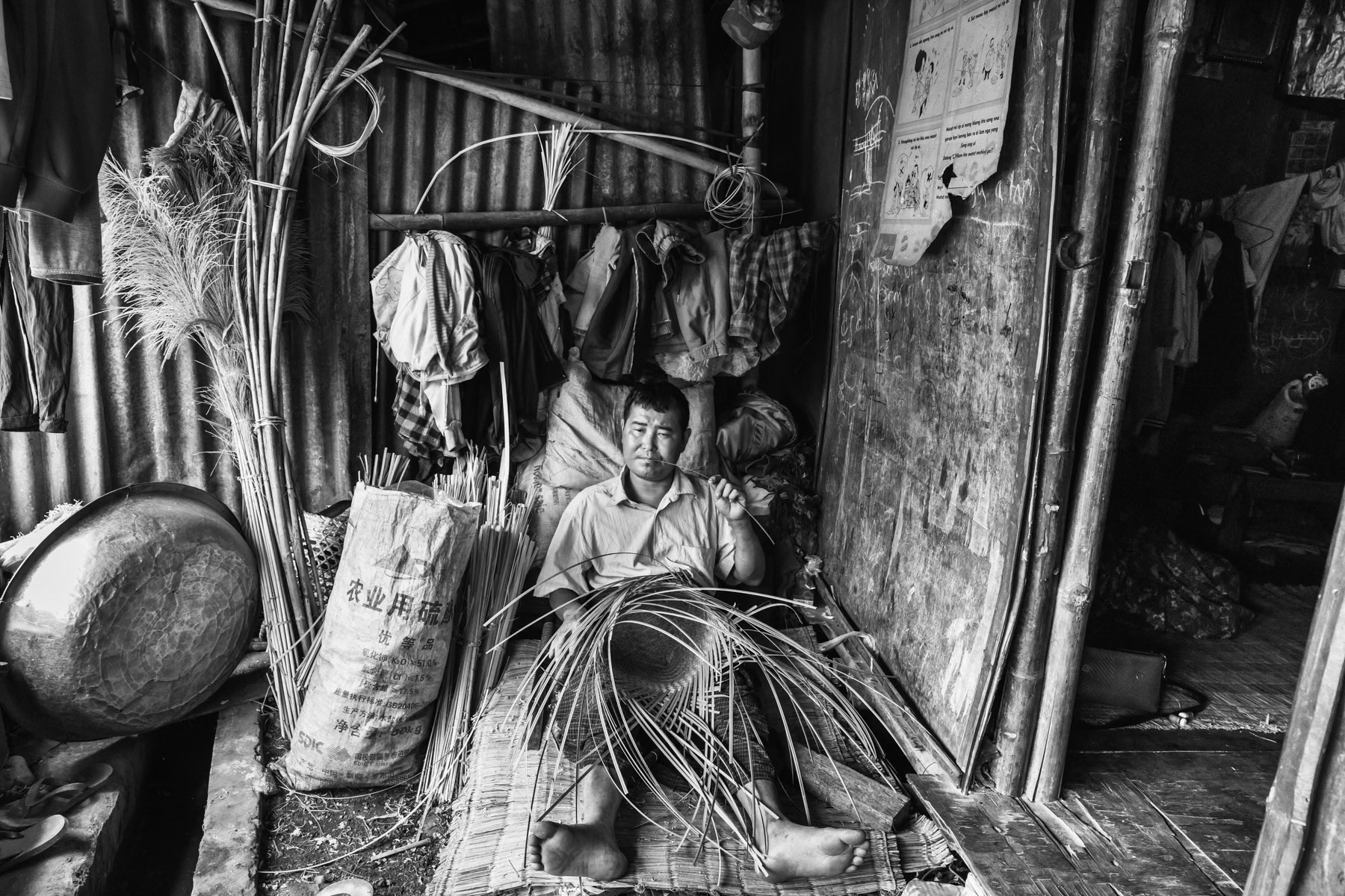 Kachin man expelled from his land earning a living in an IDP camp along the border with China in Kachin Independence Army (KIA) held territory in Myanmar. More than 6000 displaced Kachin live in Woichyai camp near Laiza the stronghold of the KIA. Laiza, Myanmar, April 2019