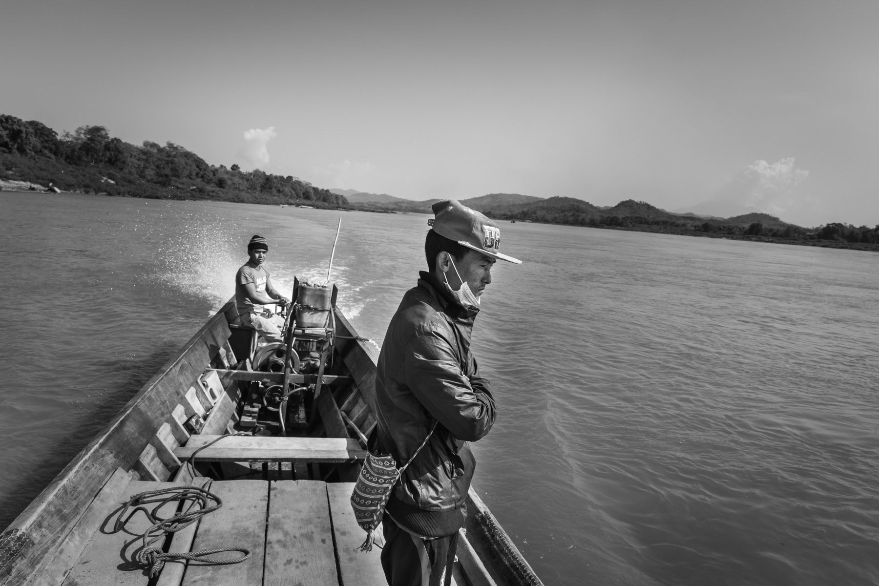 Crossing the Irrawaddy river. A controversial dam project in this area as part of the Chinese Belt and Road infrastructure projects that will undoubtly erase numerous villages along the river and deprive the local Kachin population of fertile lands. The project has been shelved but could be restarted very soon. The electricity produced by the dam would for more than 90% go to bordering Yunnan province in China. Irrawaddy river, Myitkyina, Kachin State, March 2019
