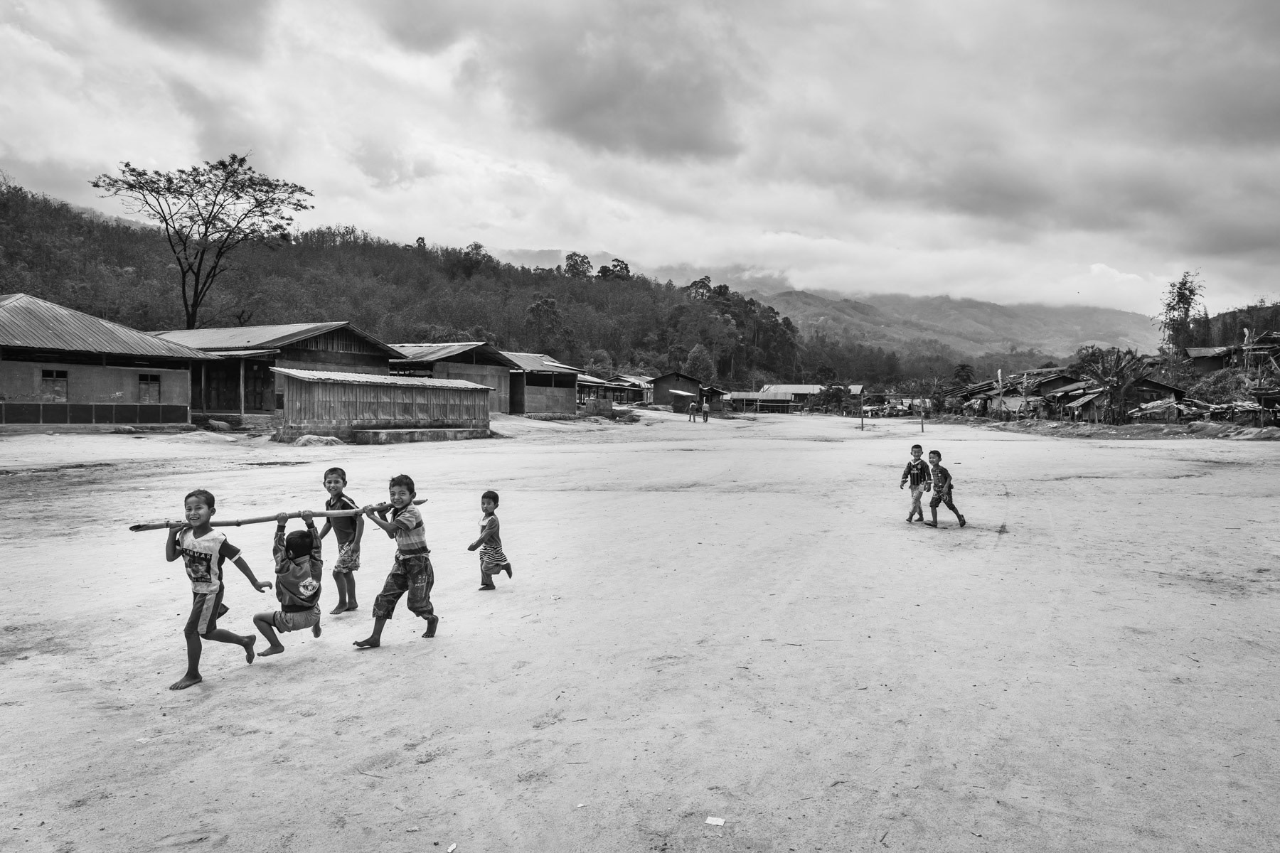Kachin children playing in an IDP camp along the border with China in Kachin Independence Army (KIA) held territory in Myanmar. More than 8700 displaced Kachin live in Je Yang camp one hour south of Laiza, the stronghold of the KIA. Je Yang camp in Laiza Township, Myanmar, April 2019
