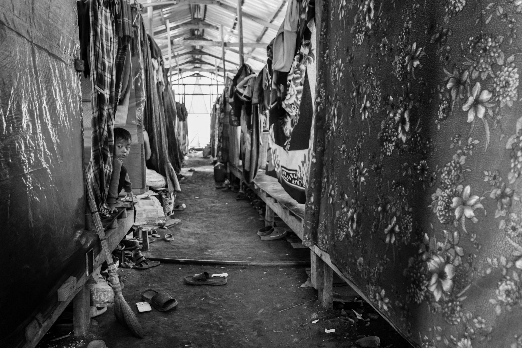 Chin child in his temporary shelter in a refugee camp on the border with Myanmar. Zokhawthar, Mizoram in India, November 2022