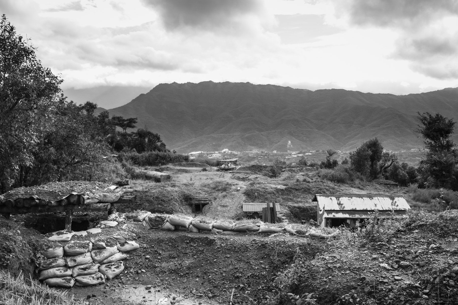 Thantlang town seen from the Chin Defence Forces (CDF) position in the mountains. Thantlang was burnt to the ground by Tatmadaw, the Burmese military in September 2021. The civilian Chin population fled and now the city is divided in two between the Chin Forces on one side and the Myanmar military in the area around their base. CDF positions overlooking Thantlang, Chin, Myanmar, September 2022