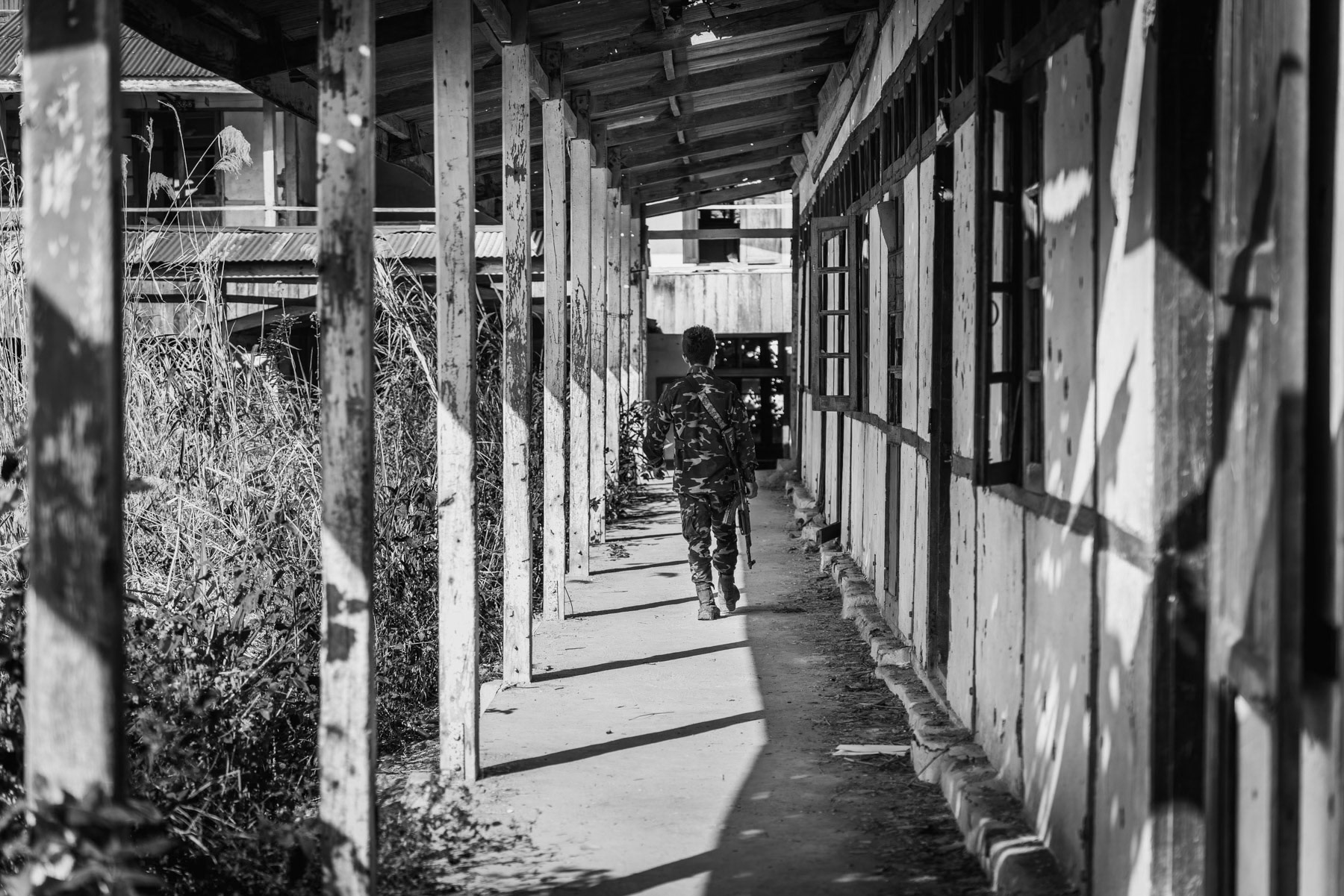 Member of the Chin Defense Forces at the frontline in a school facing the Myanmar military positions. The town has been emptied of its civilian population and is since then bitterly fought over. At this stage both sides control more or less 50% of Thantlang. Thantlang school building, Chin State, Myanmar, April 2024