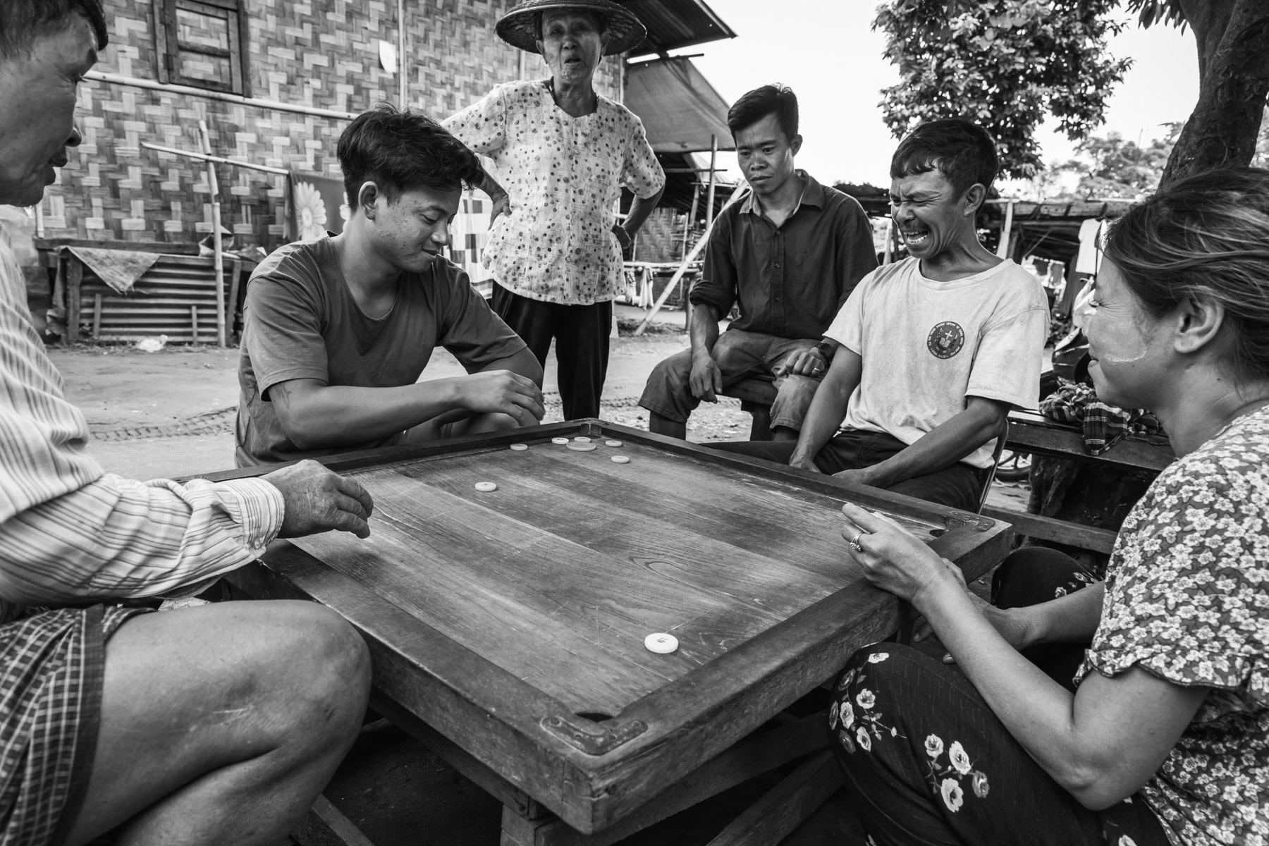 Kachin displaced persons playing games in N Jang Dung IDP camp near Myitkyina in Kachin State. Their village is located on the frontline and their land was confiscated and is now being used for banana plantations managed by Chinese companies in agreement with the military. Kachin State, Myanmar, September 2019