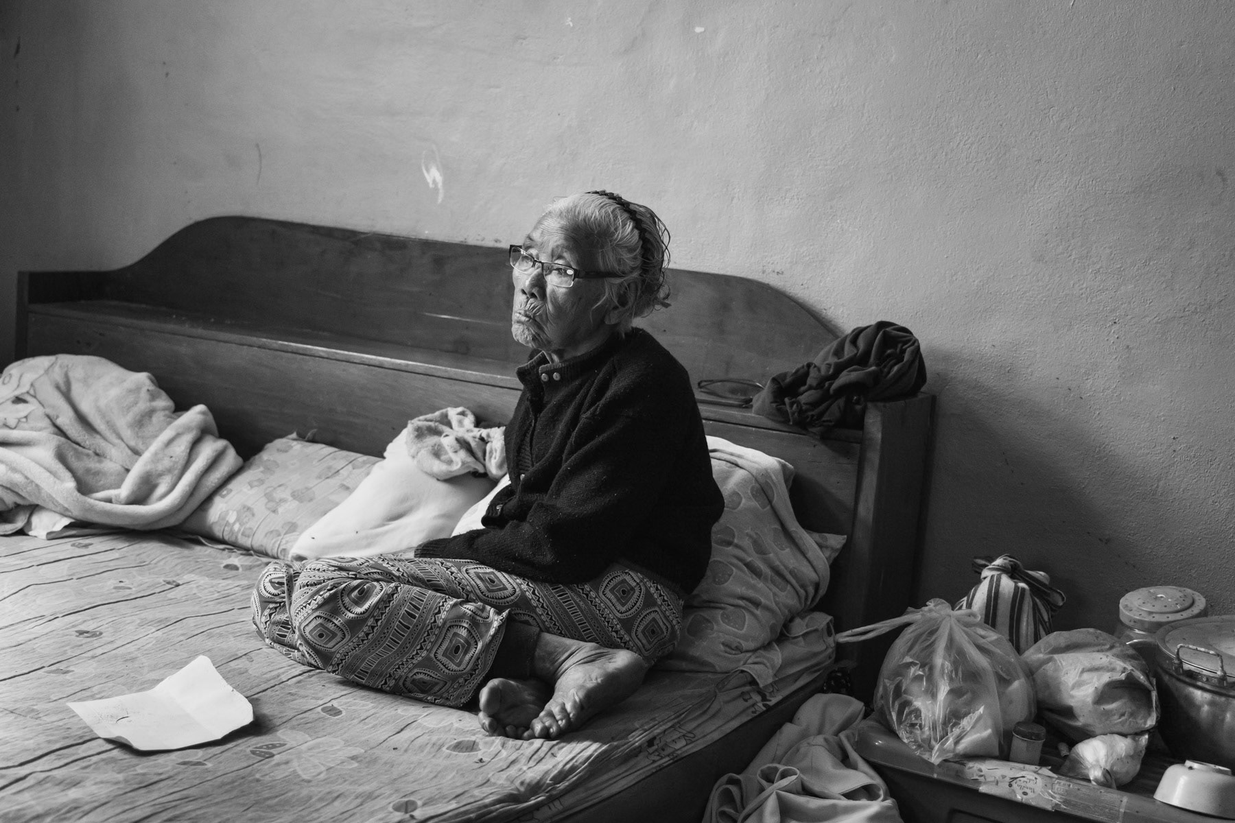 Great grand mother, 96 years old, from the Karen ethnic minority. Was born in Bago in central Myanmar from where she moved to Kayin State, A Karen majority State, but from where she had to flee after their village was attacked by the military junta and their house destroyed by shelling. Since January she has been living with her daughters and grand daughters in a rented house on the border with Thailand. Ban Pha Dee, Thailand, May 2022