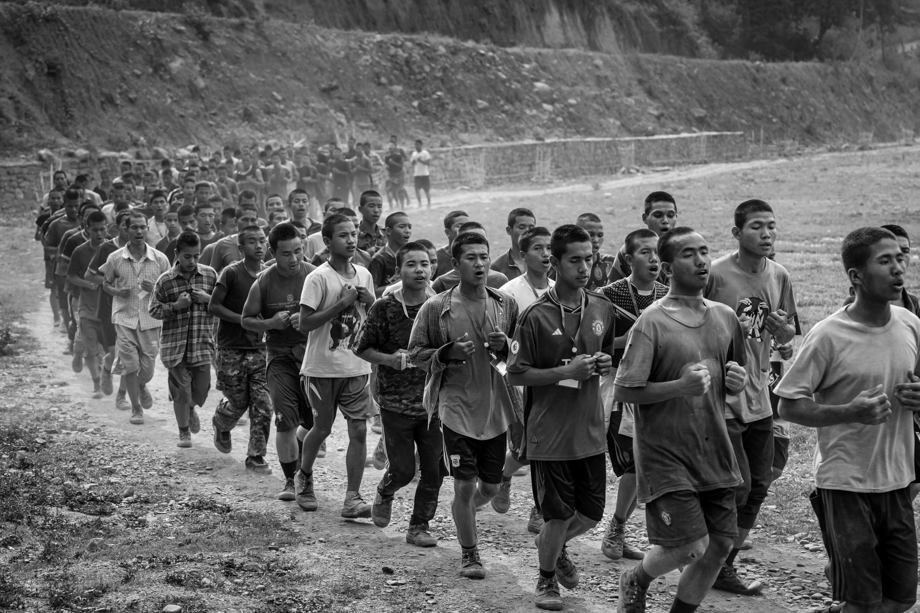 New recruits for the Chin National Army (CNA) doing physical exercises during their lenghty training before integrating the CNA. The ever increasing air strikes and forced military service enacted by the military dictatorship, has substantially increased the number of people that engage and seek refuge with the ethnic armed groups opposing the military coup leaders. CNA HQ, Camp Victoria in Chin State, Myanmar, April 2024