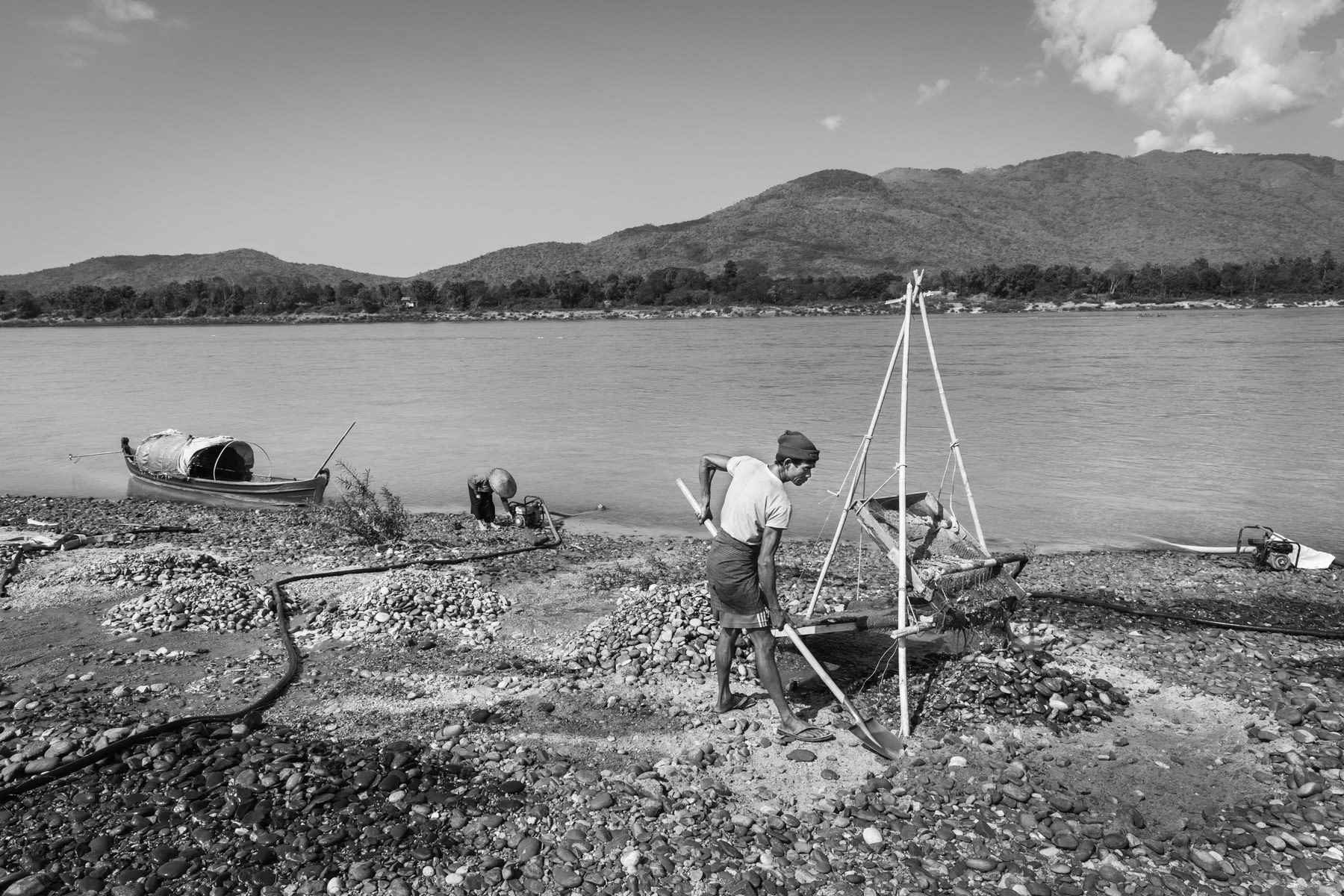 A local Kachin villager and his family searching for gold along the Irrawaddy river north of Myitkyina in Kachin State, Myanmar, March 2019