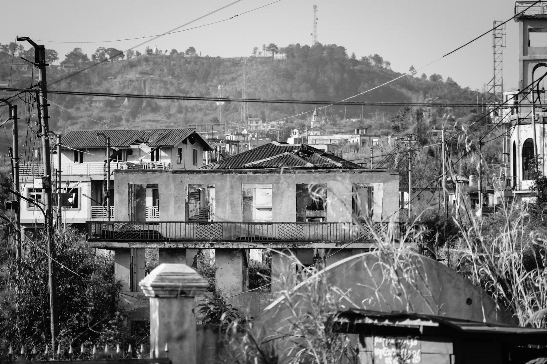 Thantlang downtown frontline facing the Myanmar military positions on the opposite hill from where the town is repeatedly shelled. The civilian population has been evacuated in September 2021 after the military shelled it and burned it down. Thantlang downtown, Chin State, Myanmar, April 2024