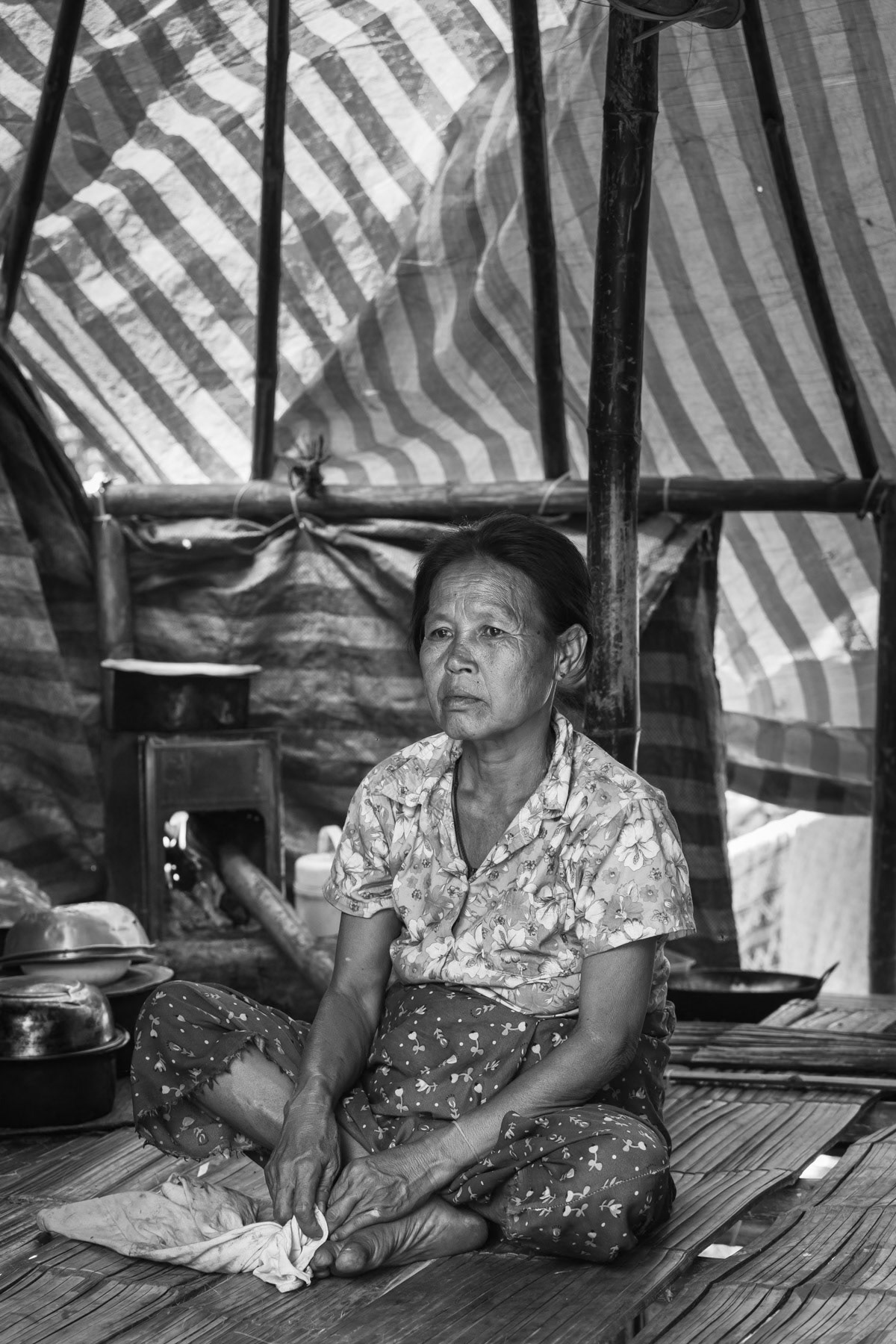 Karen woman in a camp near the Thai border in territory controlled by the Karen National Liberation Army (KNLA). They have fled their villages after repeated air attacks by the Myanmar military. Widwspread terror and attacks against civilians and ethnic minorities have substantially increased since the military coup in 2021, provoking large numbers of displaced persons and refugees. Kanele IDP camp, Way Lay, Kayin State, Myanmar. June 2022