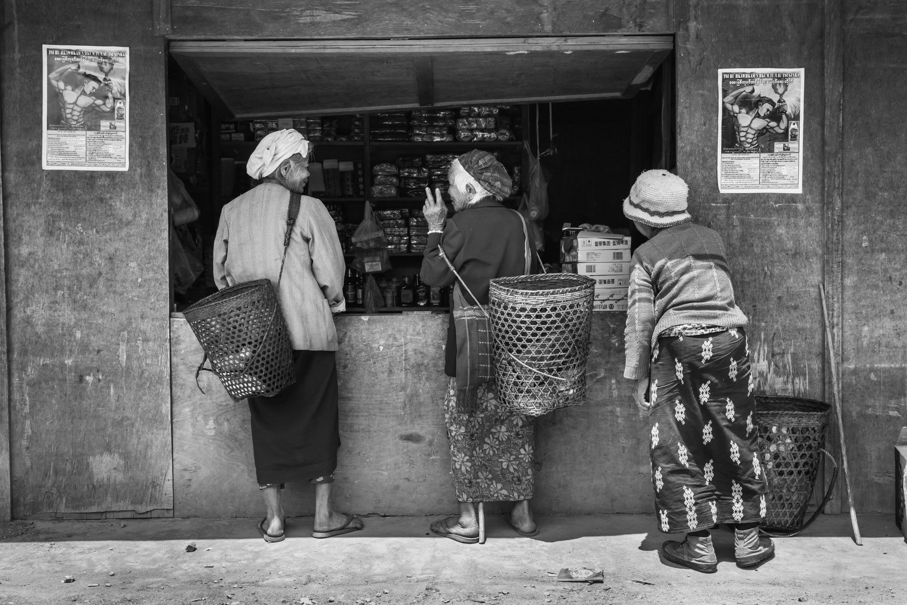 Kachin women buying and chatting at a small convenience store. Nhkawng Pa IDP Camp near Mai Ja Yang in KIA controlled territory, Myanmar, April 2019
