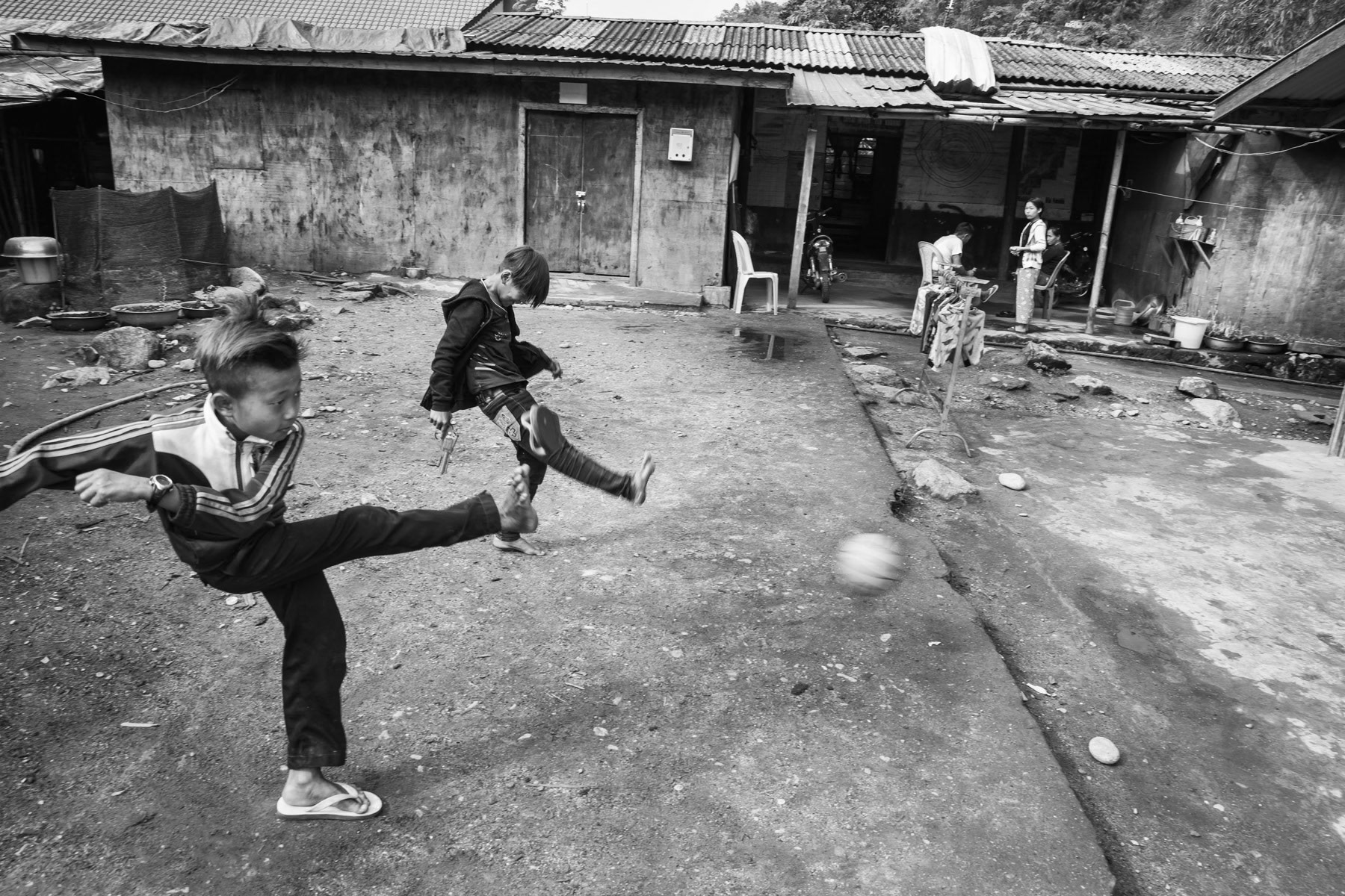 Kachin children playing football in an IDP camp along the border with China in Kachin Independence Army (KIA) held territory in Myanmar. More than 6000 displaced Kachin live in Woichyai camp near Laiza, the stronghold of the KIA. Laiza Township, Myanmar, April 2019