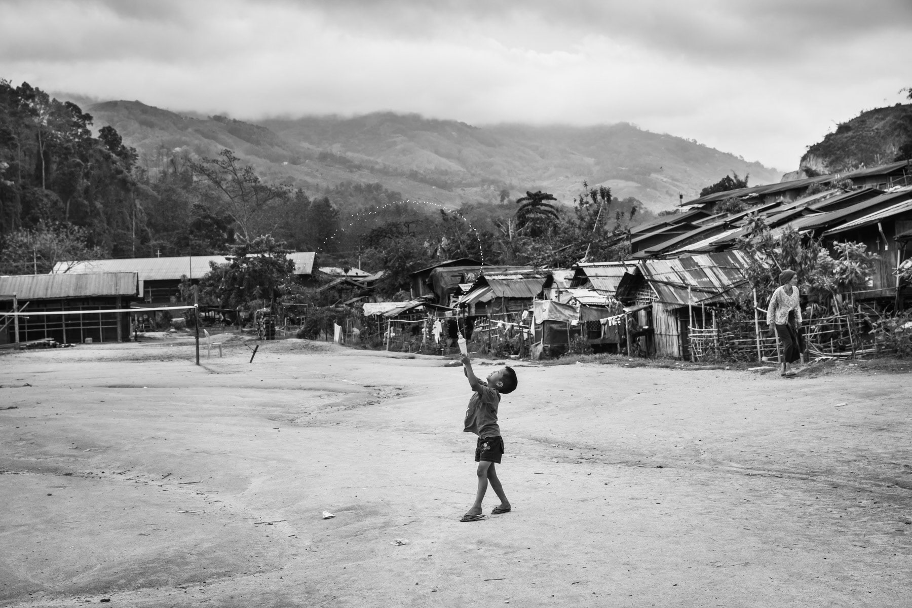 Kachin child playing in an IDP camp along the border with China in Kachin Independence Army (KIA) held territory in Myanmar. More than 8700 displaced Kachin live in Je Yang camp one hour south of Laiza, the stronghold of the KIA. Je Yang camp in Laiza Township, Myanmar, April 2019