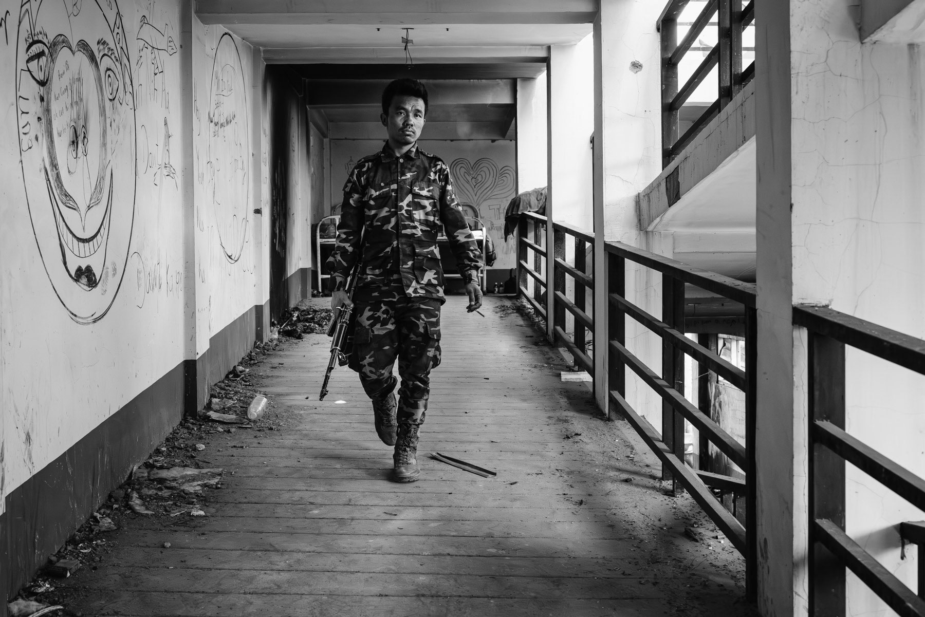 Member of the Chin Defense Forces (CDF) on the frontline in the hospital facing the Myanmar military positions. The town has been emptied of its civilian population and is since then bitterly fought over. At this stage both sides control more or less 50% of Thantlang. Thantlang hospital, Chin State, Myanmar, April 2024