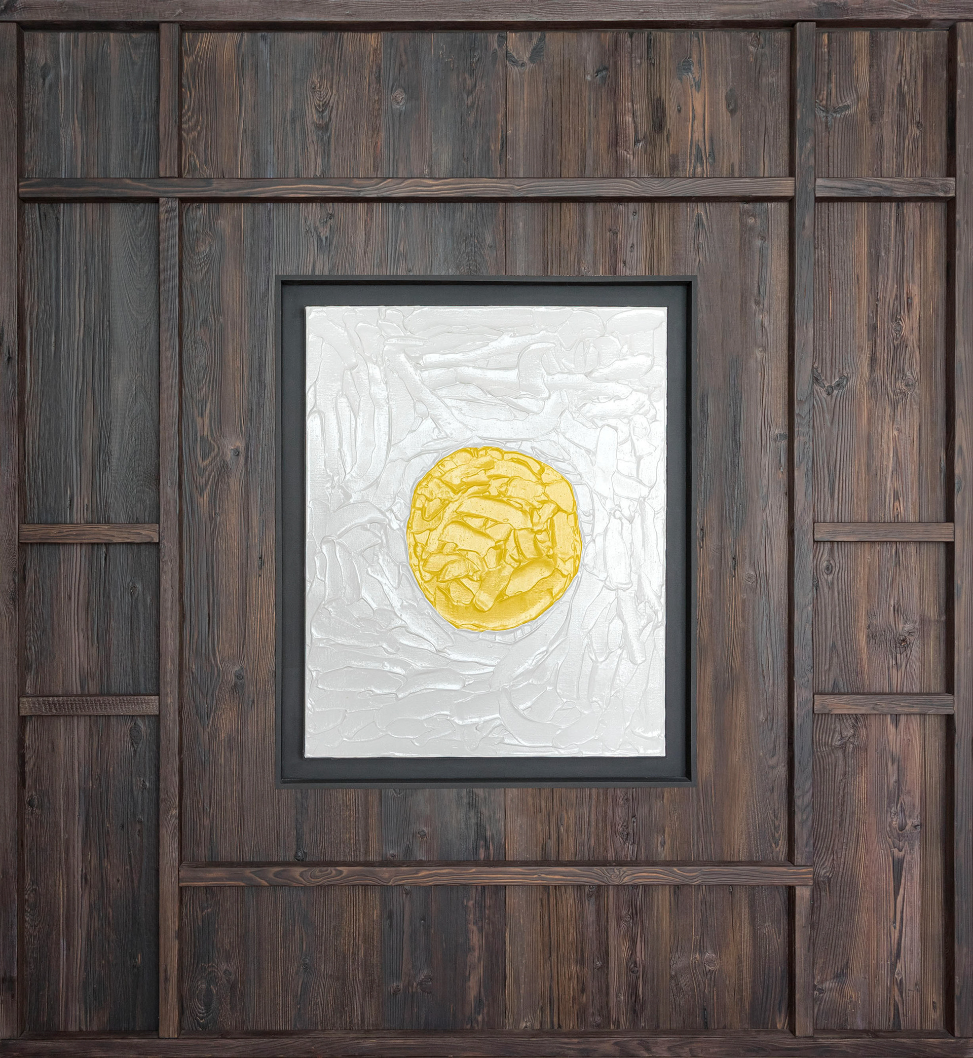 Artwork by artist Francesco Carozza centered on a wooden boiserie wall, framed by geometric designs that highlight the piece.
