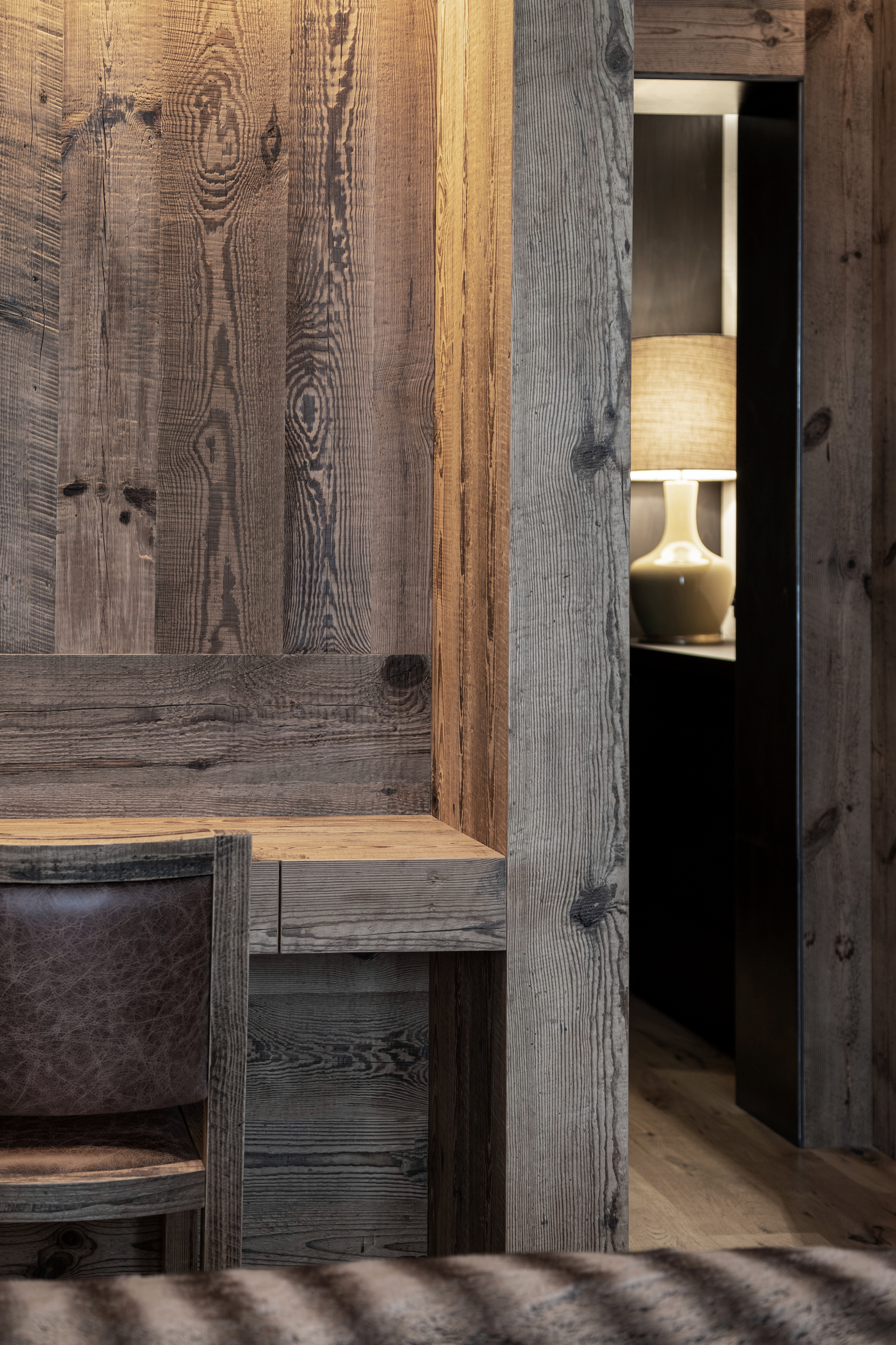 Detail of a custom-made wooden desk in the bedroom, designed as a small study area in a luxury St. Moritz project.