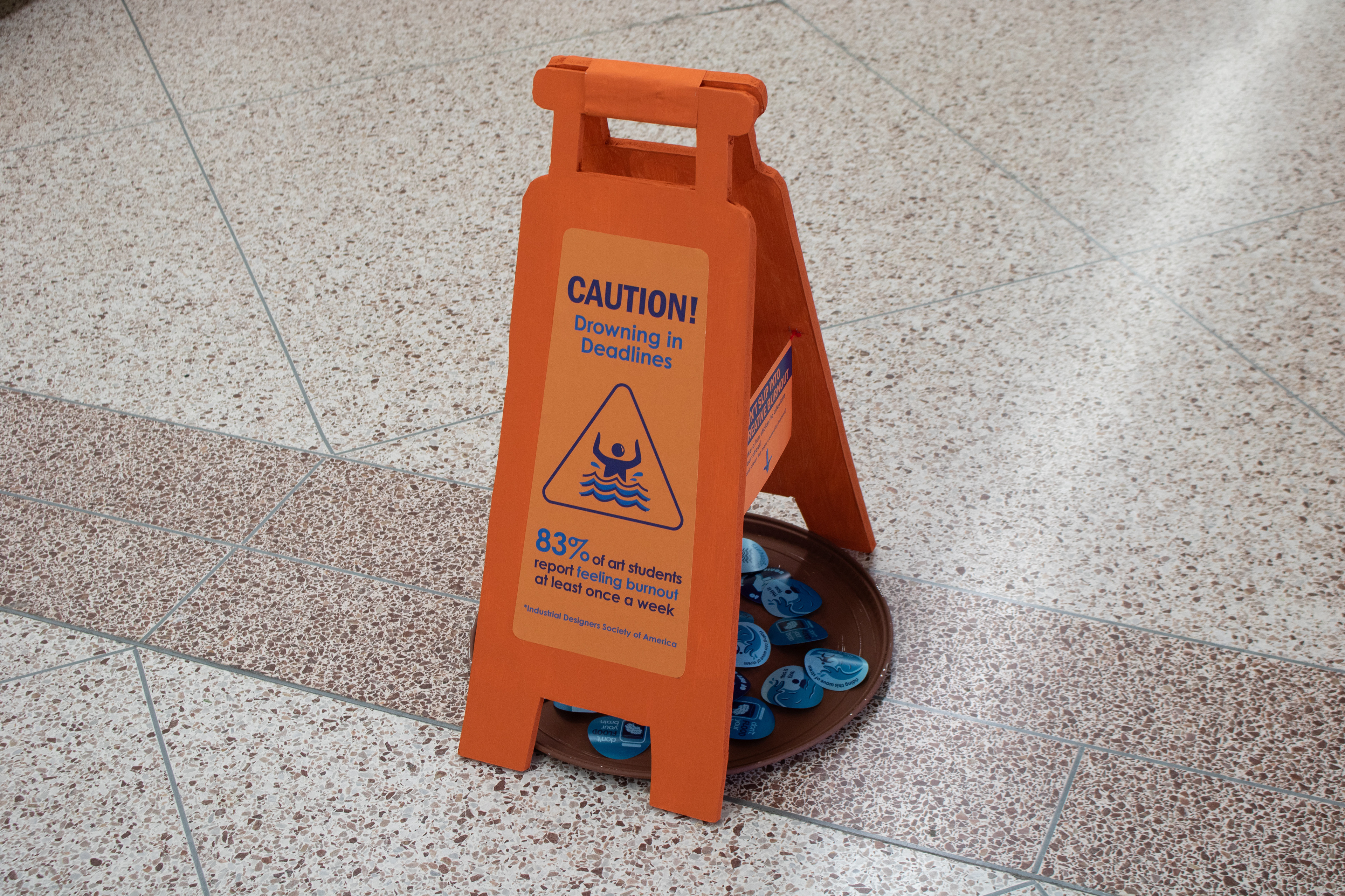 Burnout statistics on a wet floor sign.