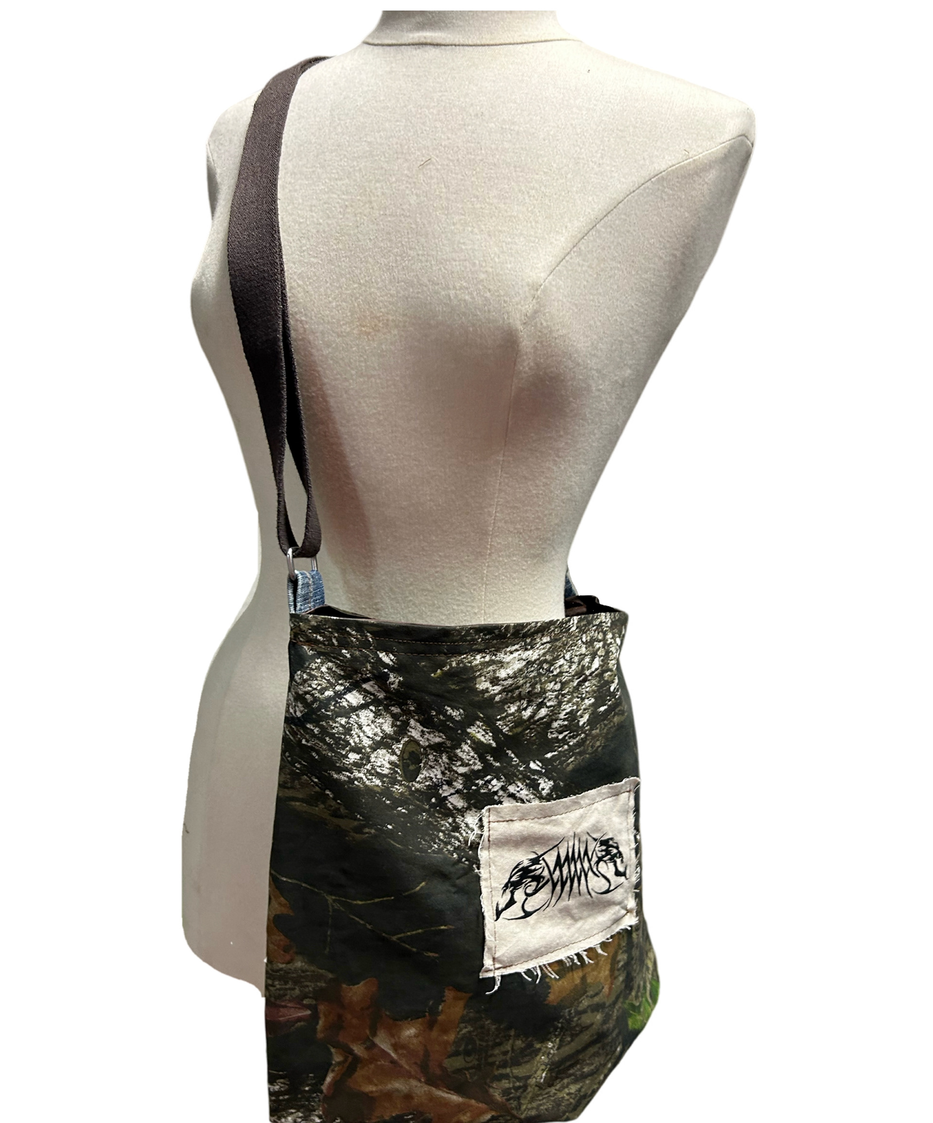 Hand made reversible bag with adjustable strap and screen printed patch. Made with new and recycled materials.