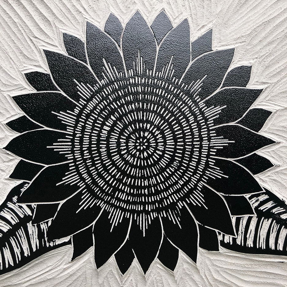 Sunflower linoleum block inked up.
