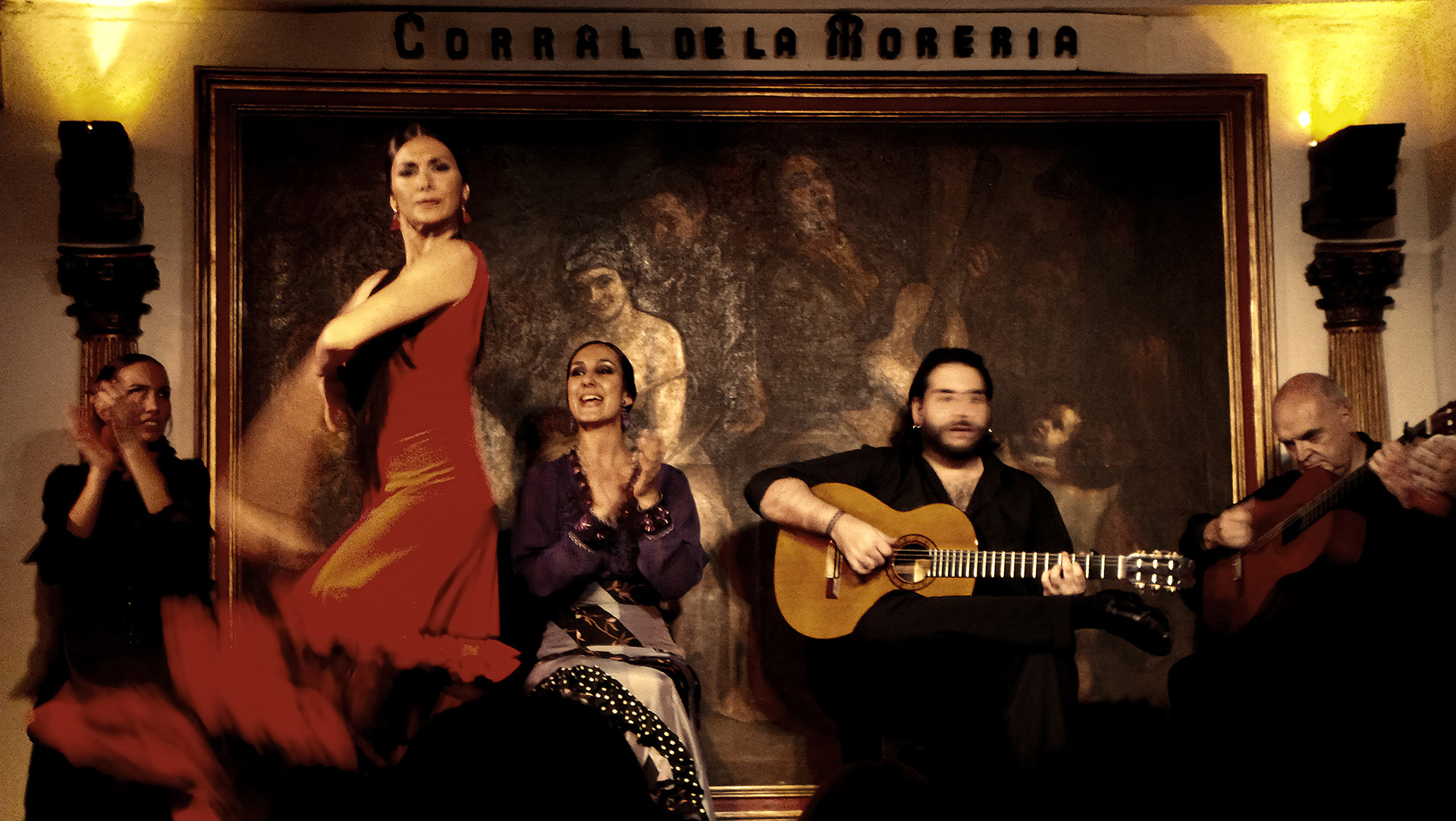 Image of a woman in a red dress dancing Flamenco in Madrid by Ryan Bucchianeri.