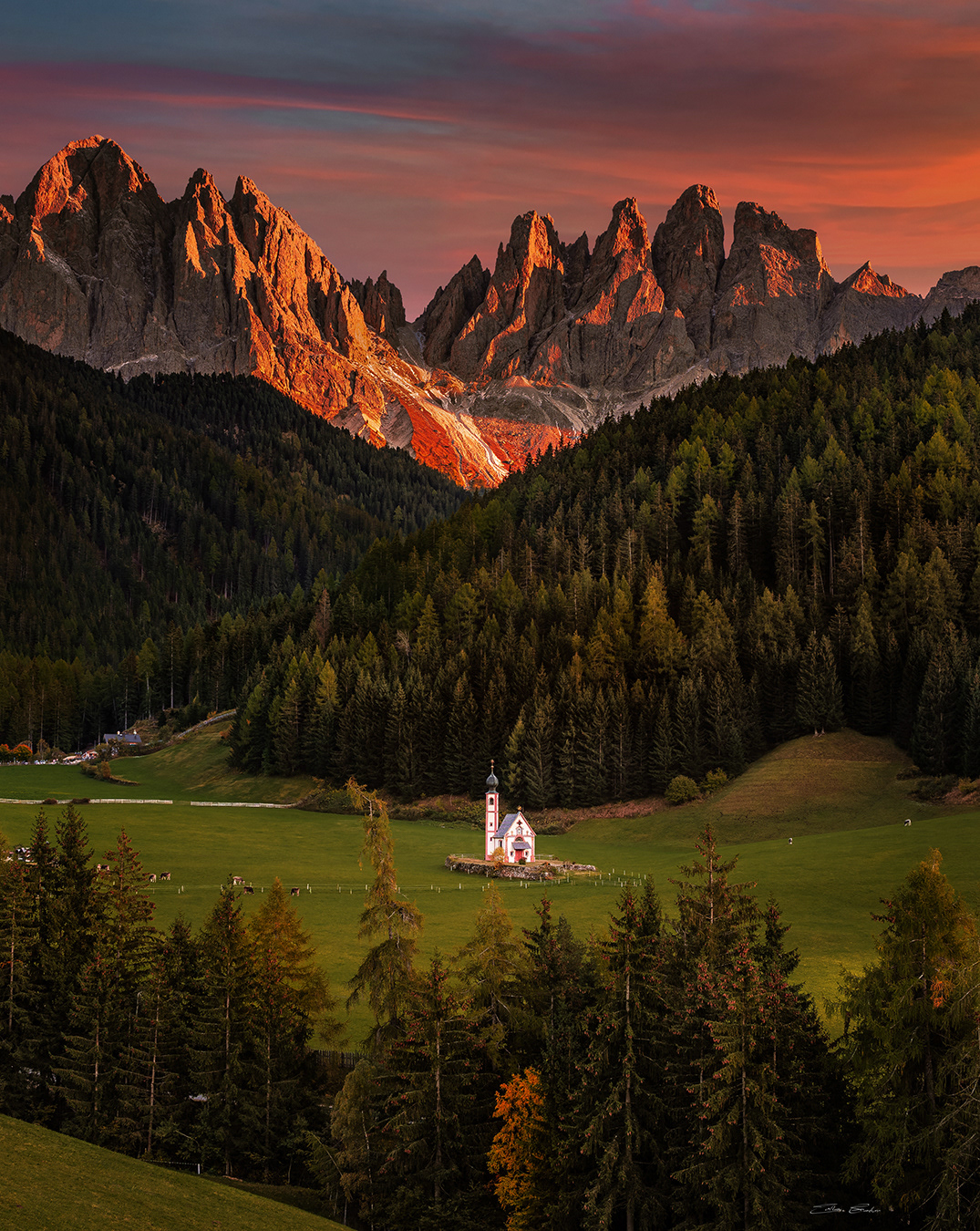 Church of St. John in Ranui at sunset with the Italian Dolomites