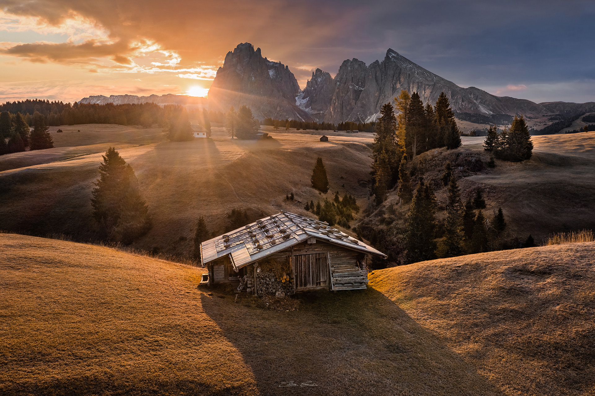 Sunrise at Seiser Alm with traditional wooden chalet