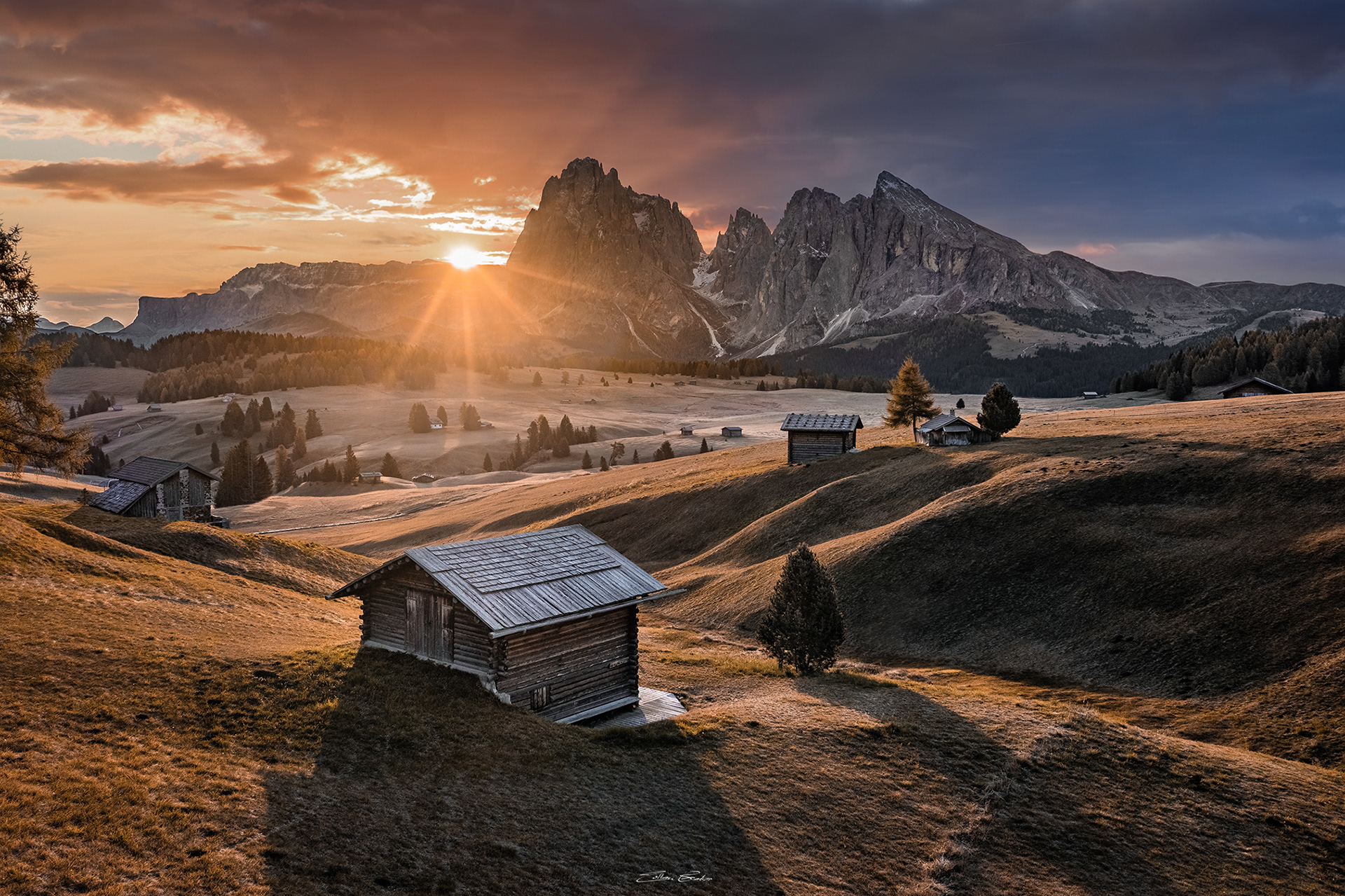 Sunrise over Seiser Alm (Alpe di Siusi) with wooden chalets
