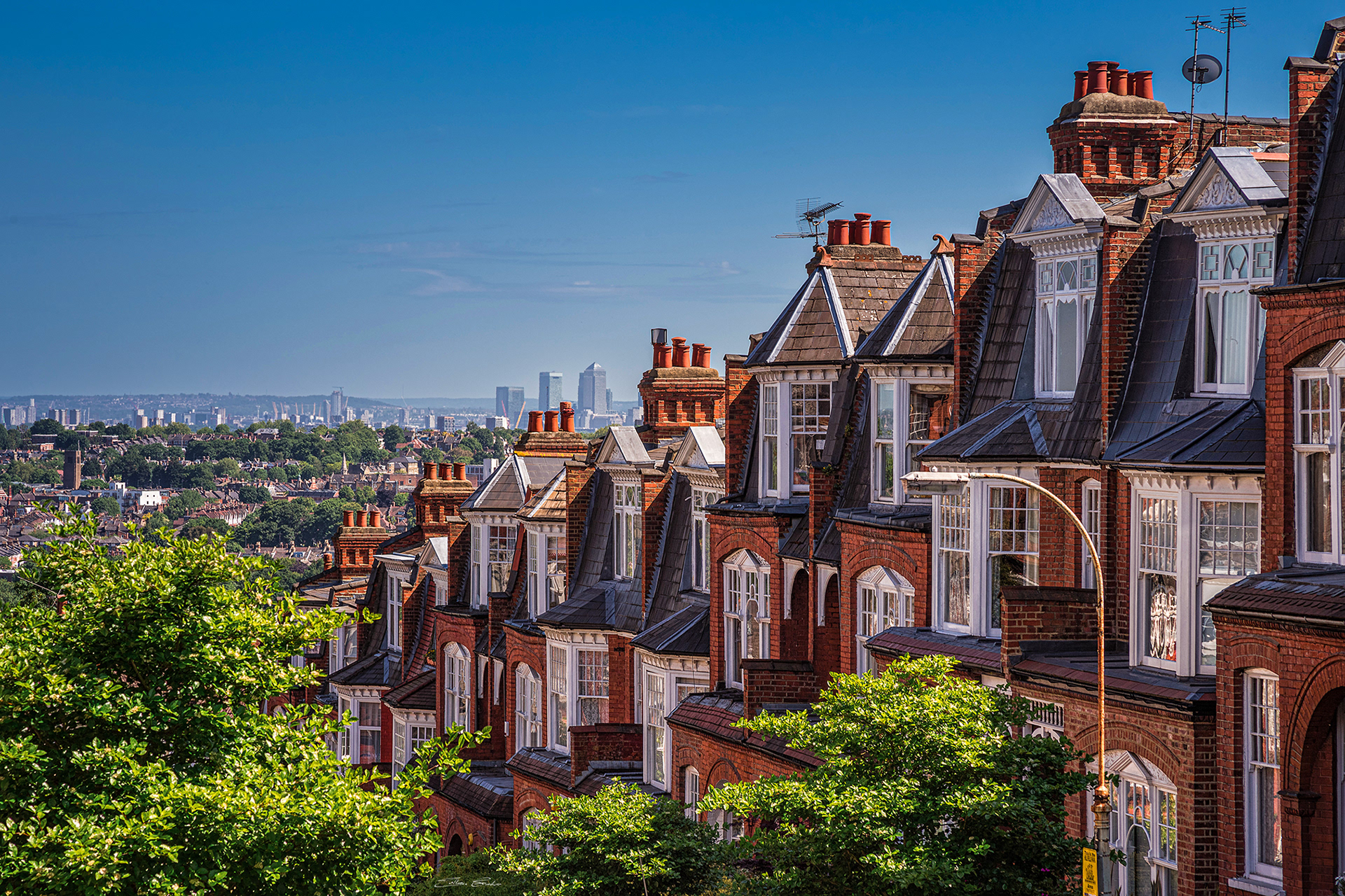 Old Victorian houses at Muswell Hill with Canary Wharf at background