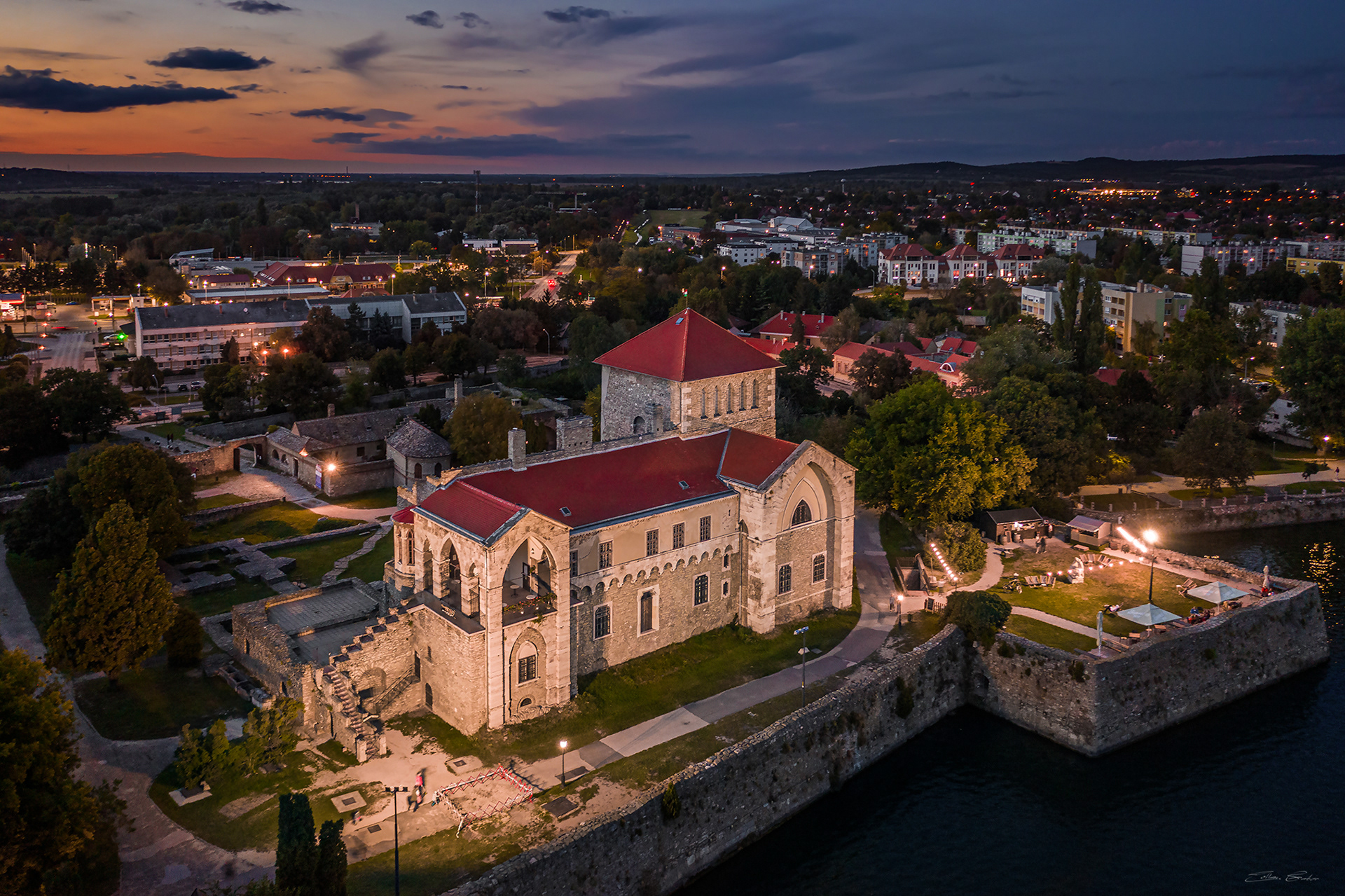 Aerial view of the Castle of Tata by the Old Lake at dusk
