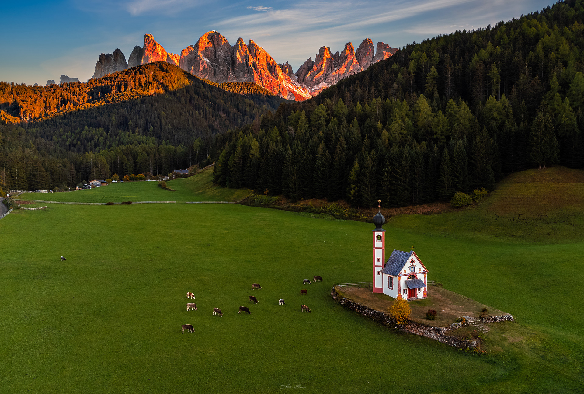 Church of St. John in Ranui at sunset with the Italian Dolomites