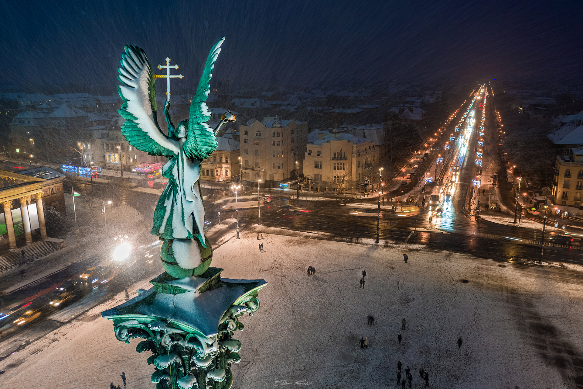Snowing at Heroes' Square with the statue of Gabriel Archangel and Andrassy Street