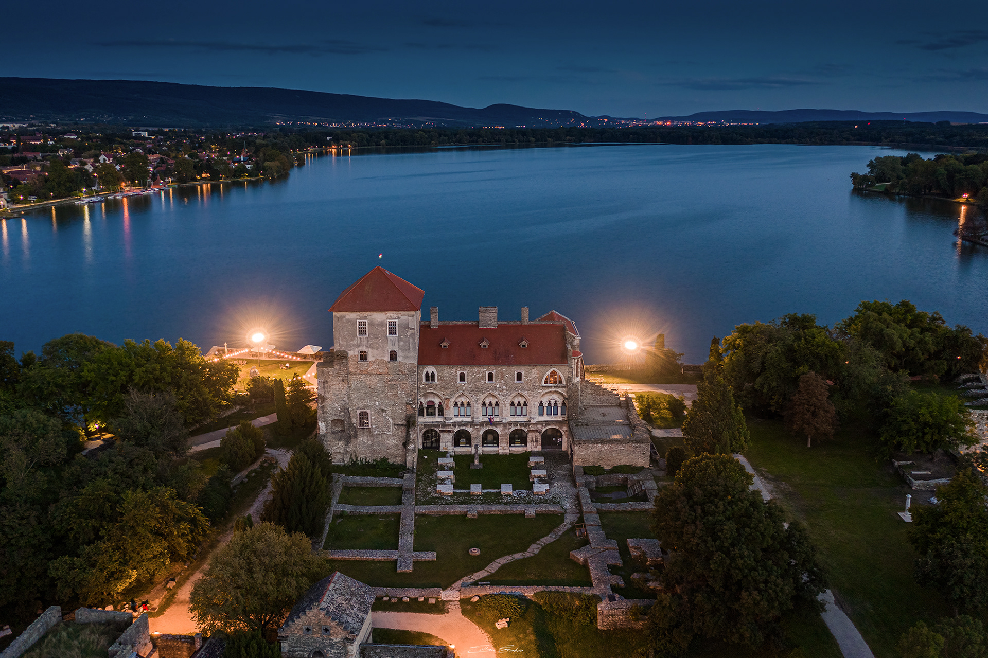 Aerial view of the Castle of Tata by the Old Lake at dusk