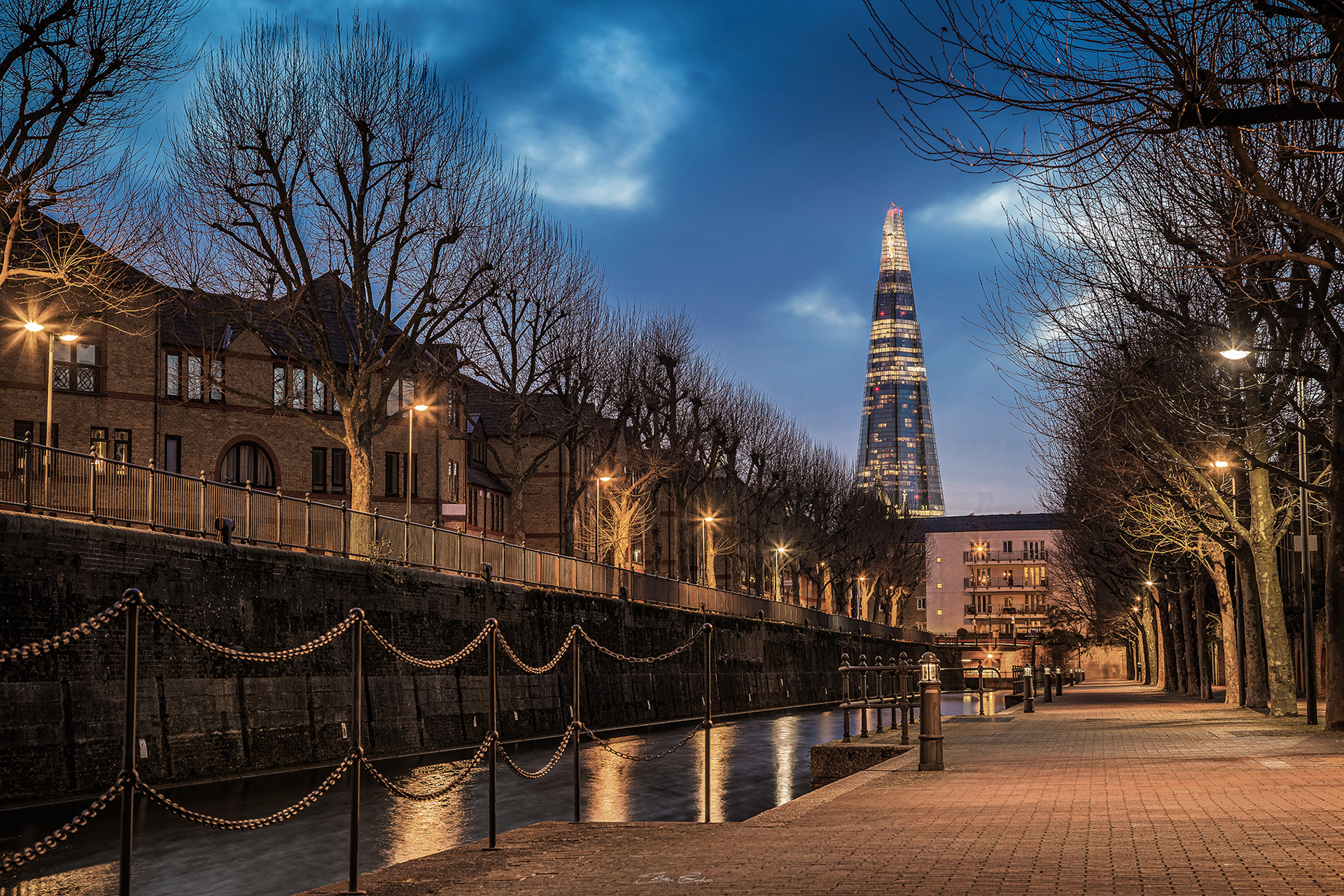 Ornamental canal at dusk with the Shard skyscraper at background