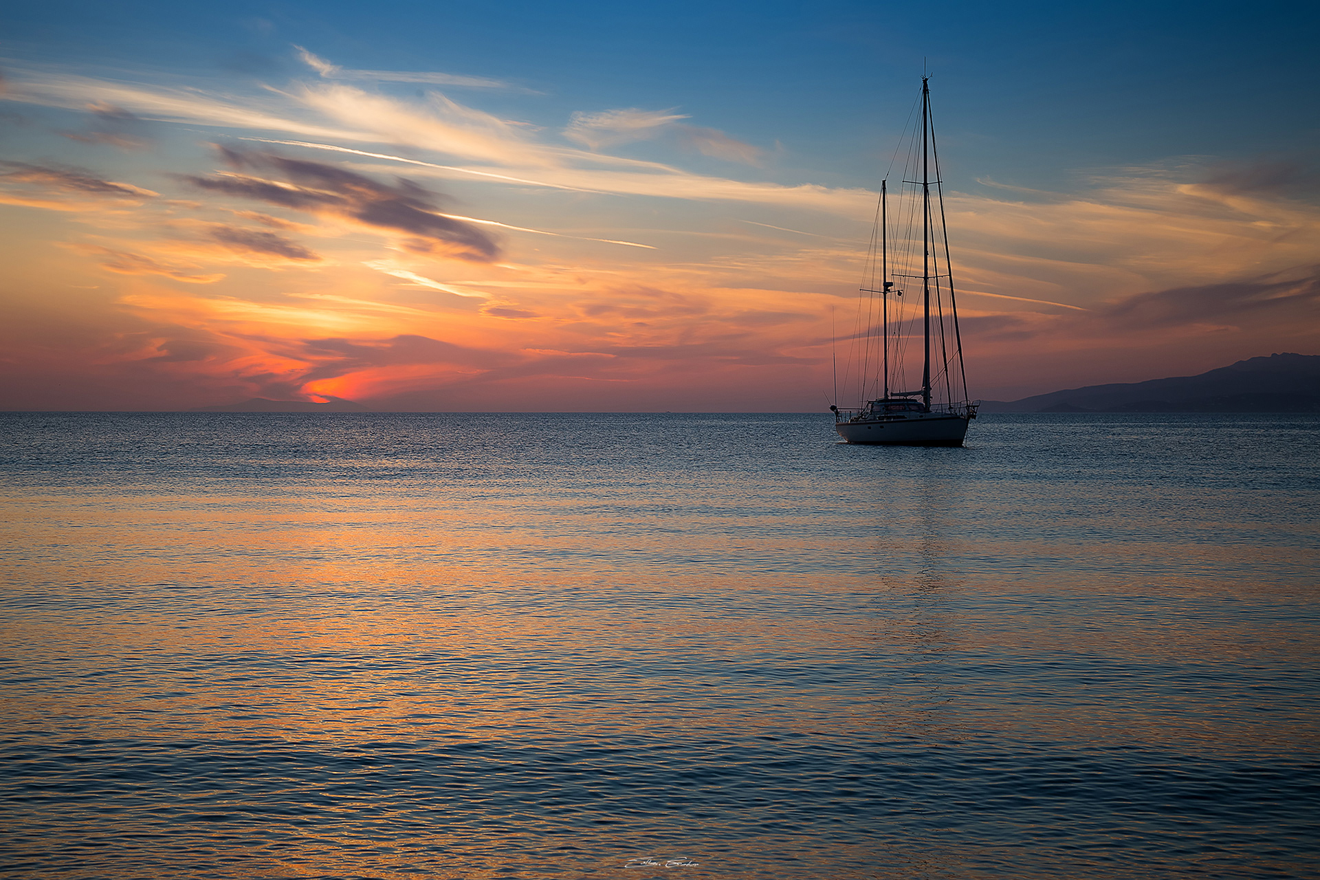 Mykonos sunset with sailboat