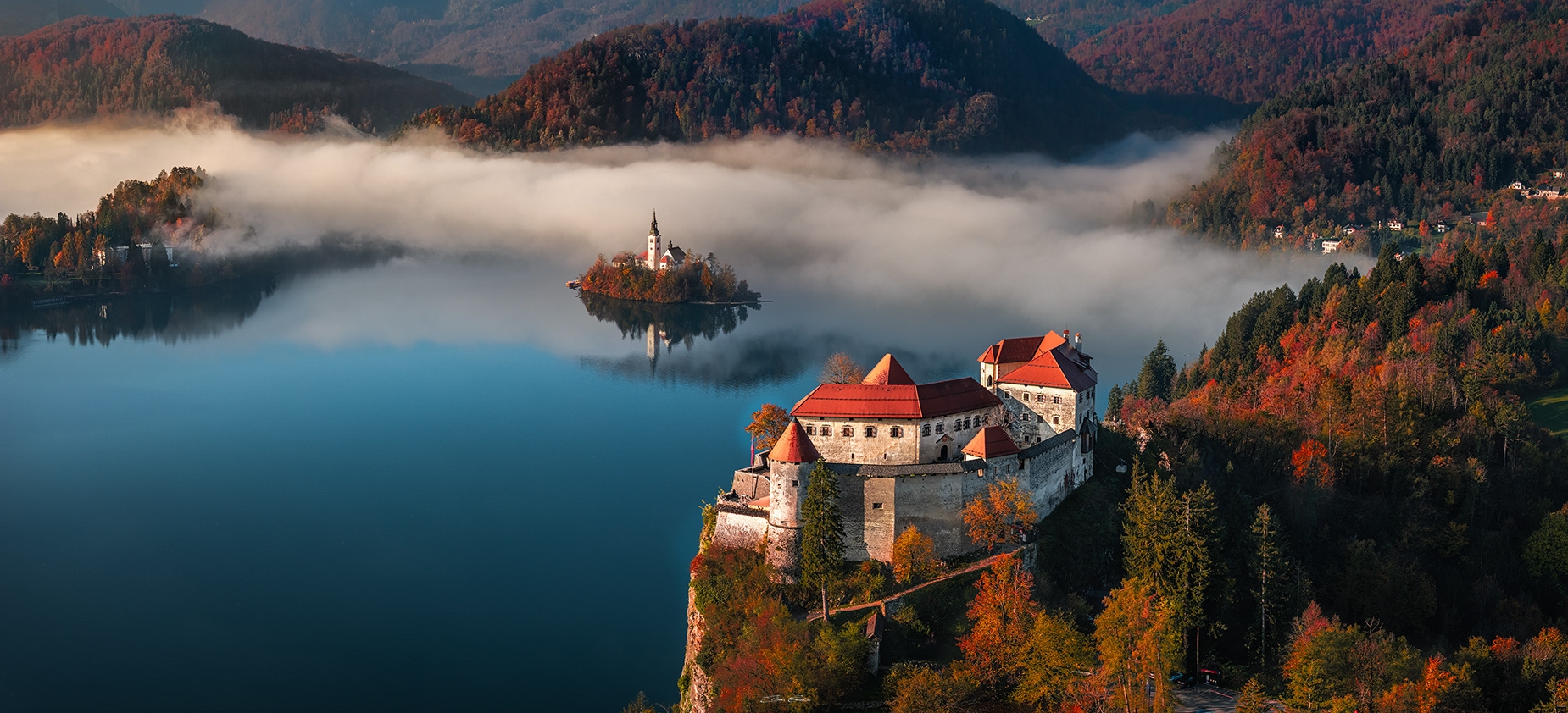 Bled Castle with Bled Island at background on a foggy autumn morning in Slovenia