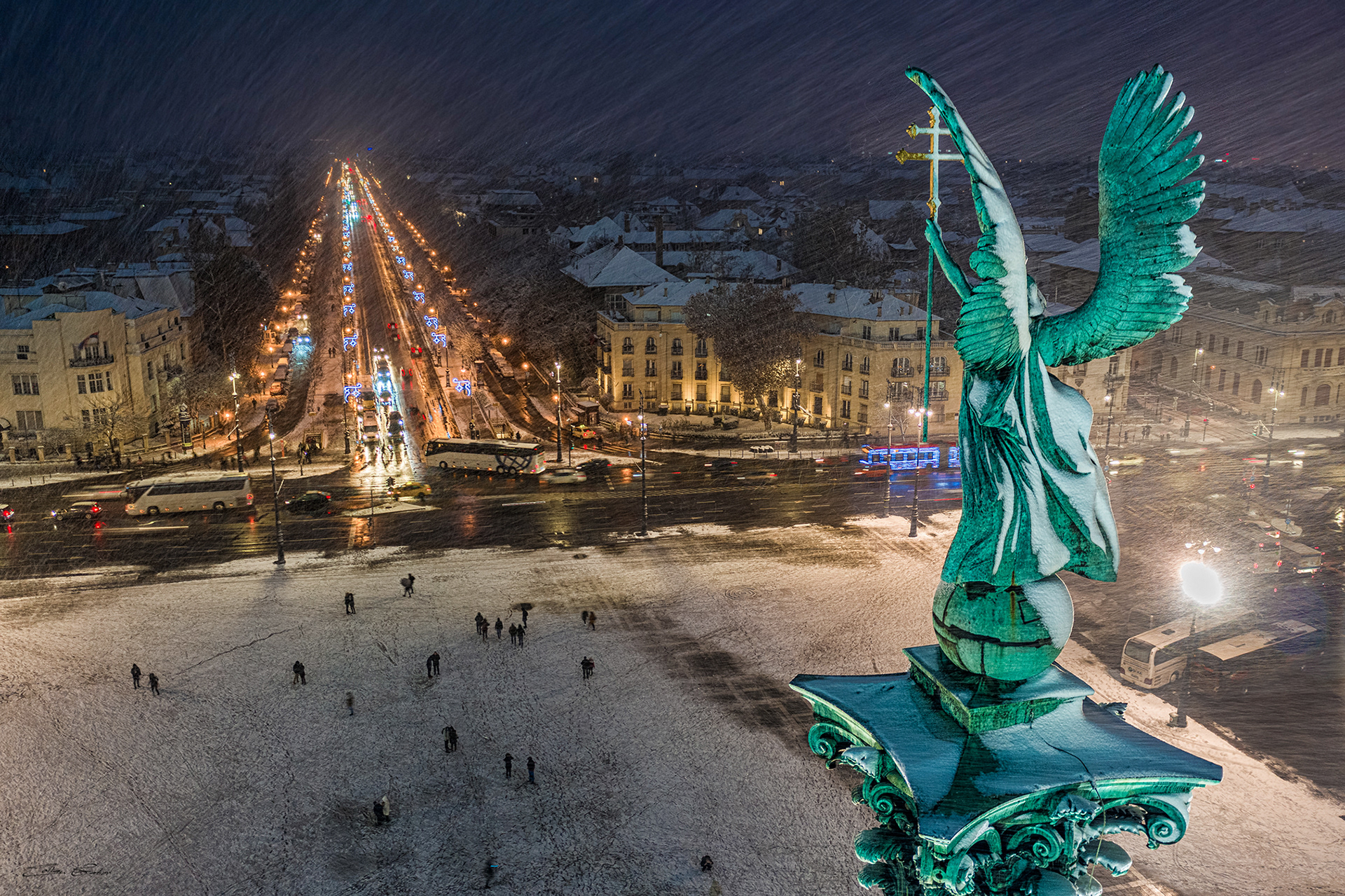 Snowing at Heroes' Square with the statue of Gabriel Archangel