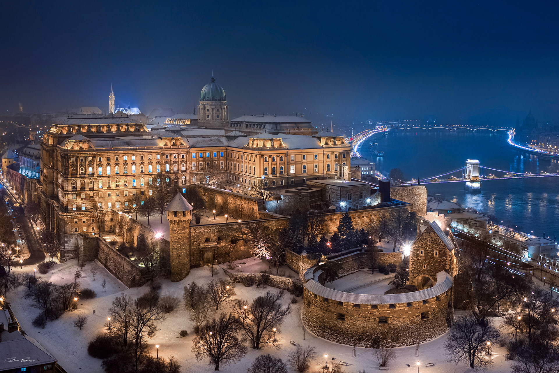 Snowy Buda Castle and Széchenyi Chain Bridge on a winter evening