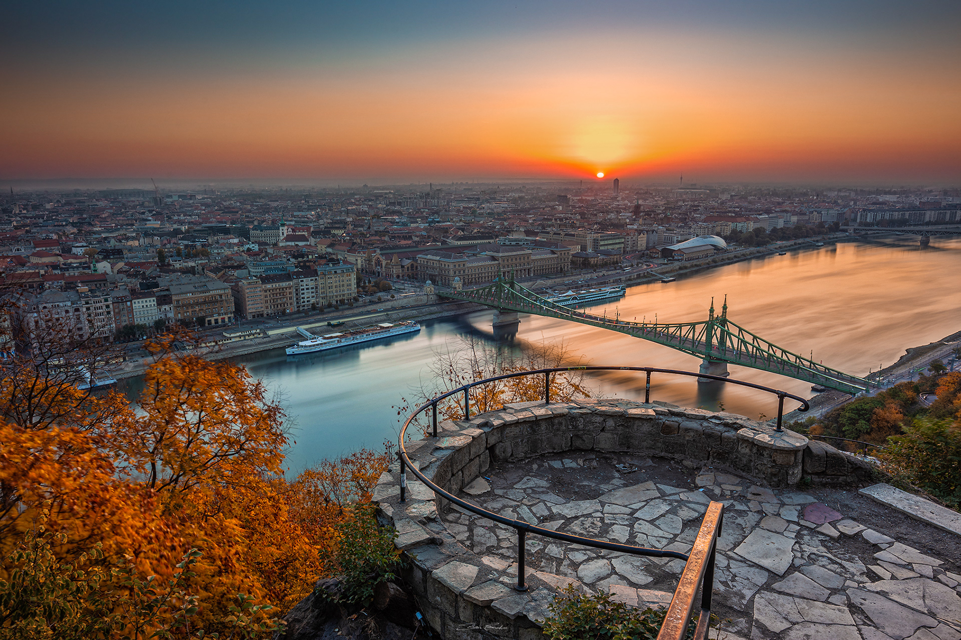 Balcony on Gellert Hill with Liberty Bridge and a beautiful autumn sunrise