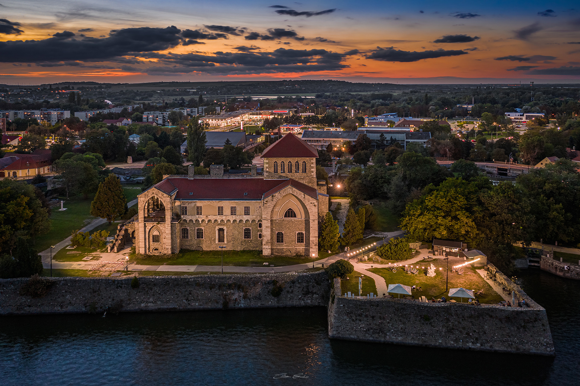 Aerial view of the Castle of Tata by the Old Lake at sunset