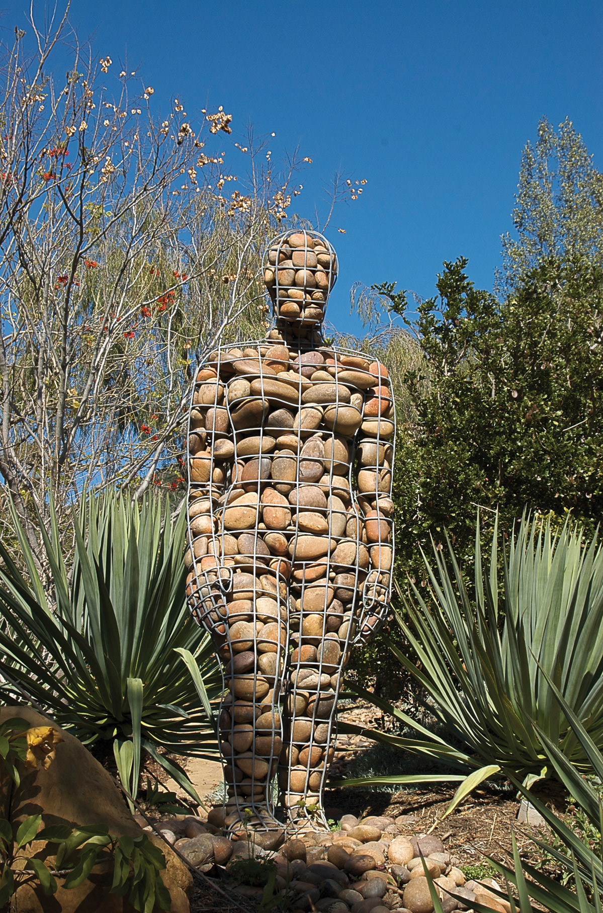 "The Walking Cairn" by Celeste Roberge, made from river stone in a steel cage