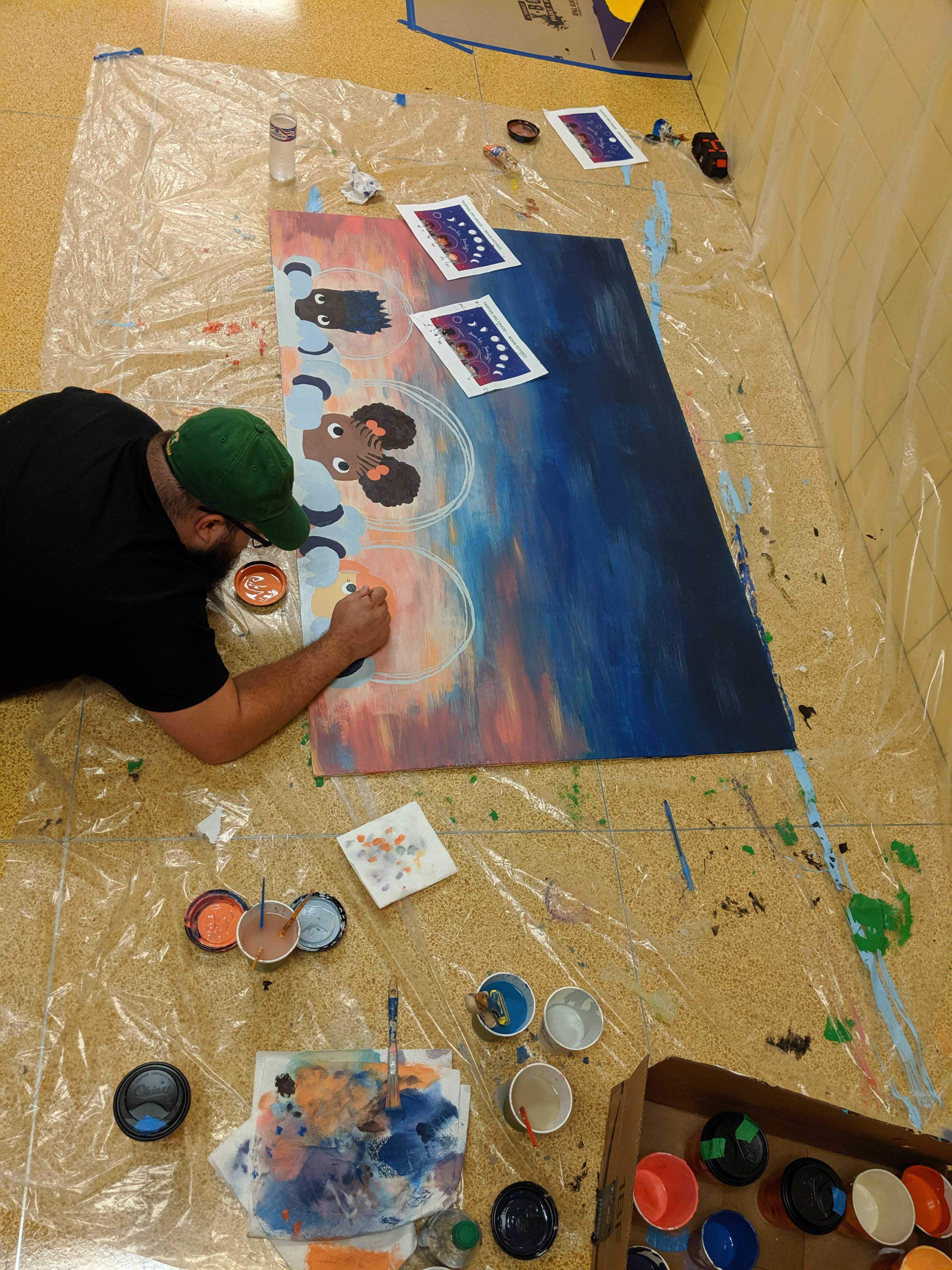 Husband helping paint mural