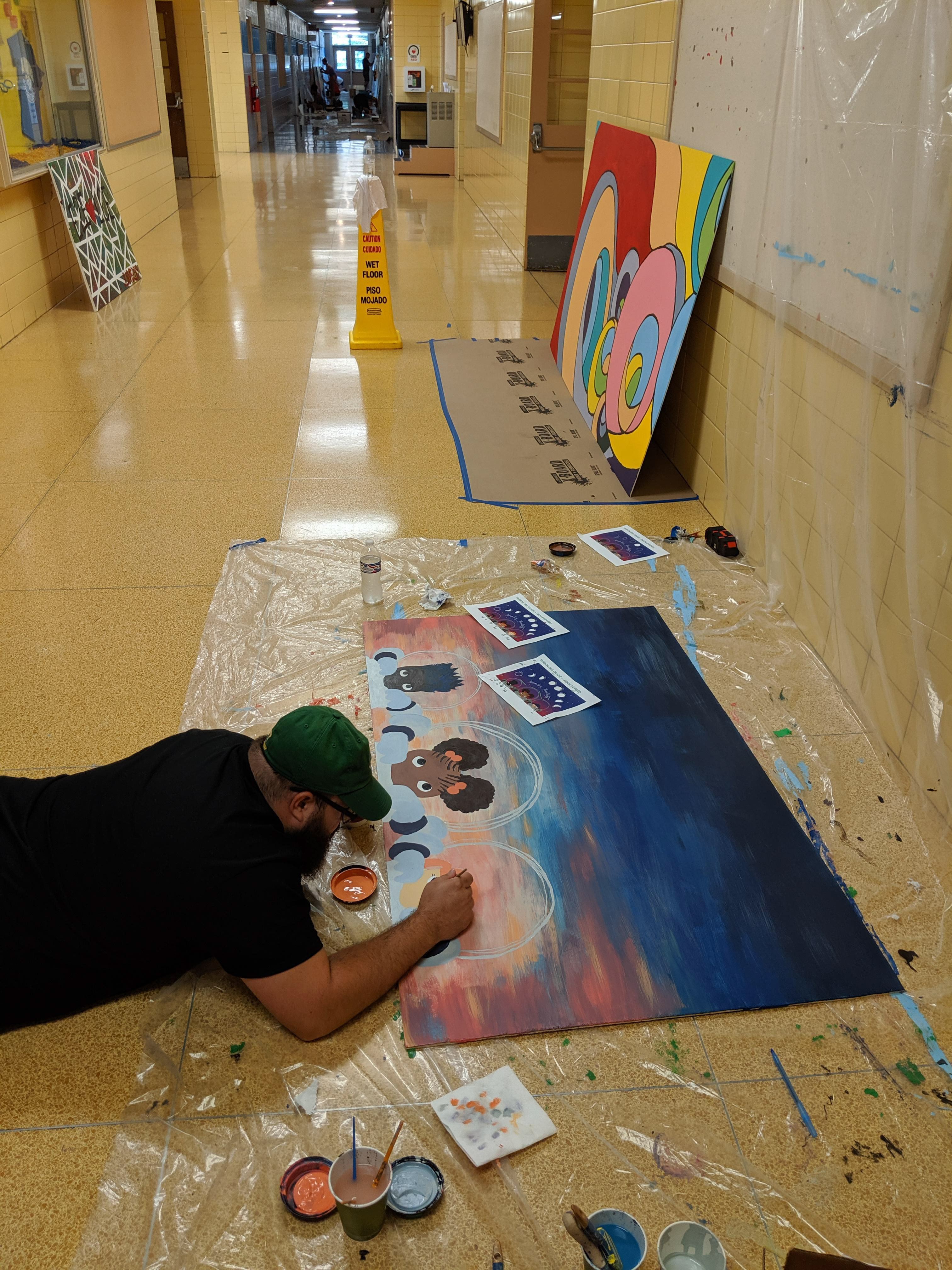 Husband helping paint mural
