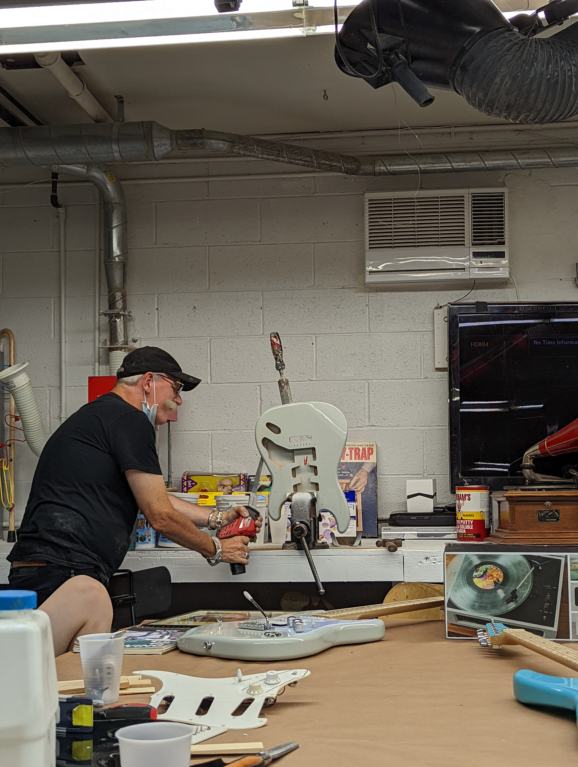 Kevin sawing a guitar in half.