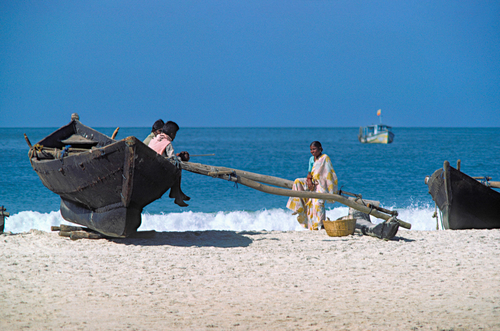 Younsters chatting on the beach, Kerala. India