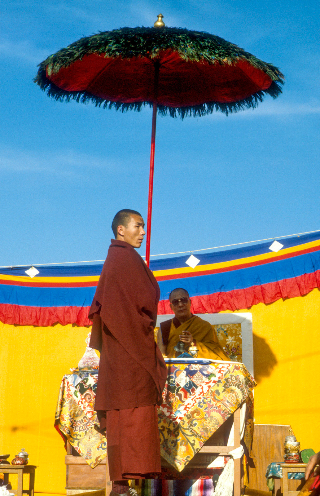 H.H. The Dalai Lama under a peacock umbrella. Dharamsala. India