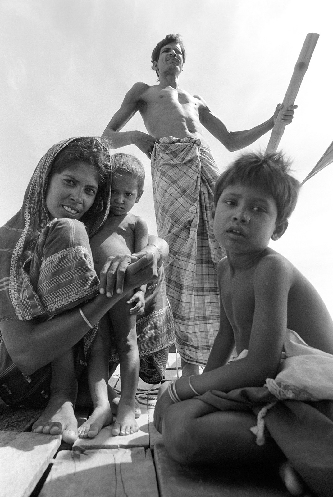 Mother and children on a small river ferry. Ganges, Bangladesh