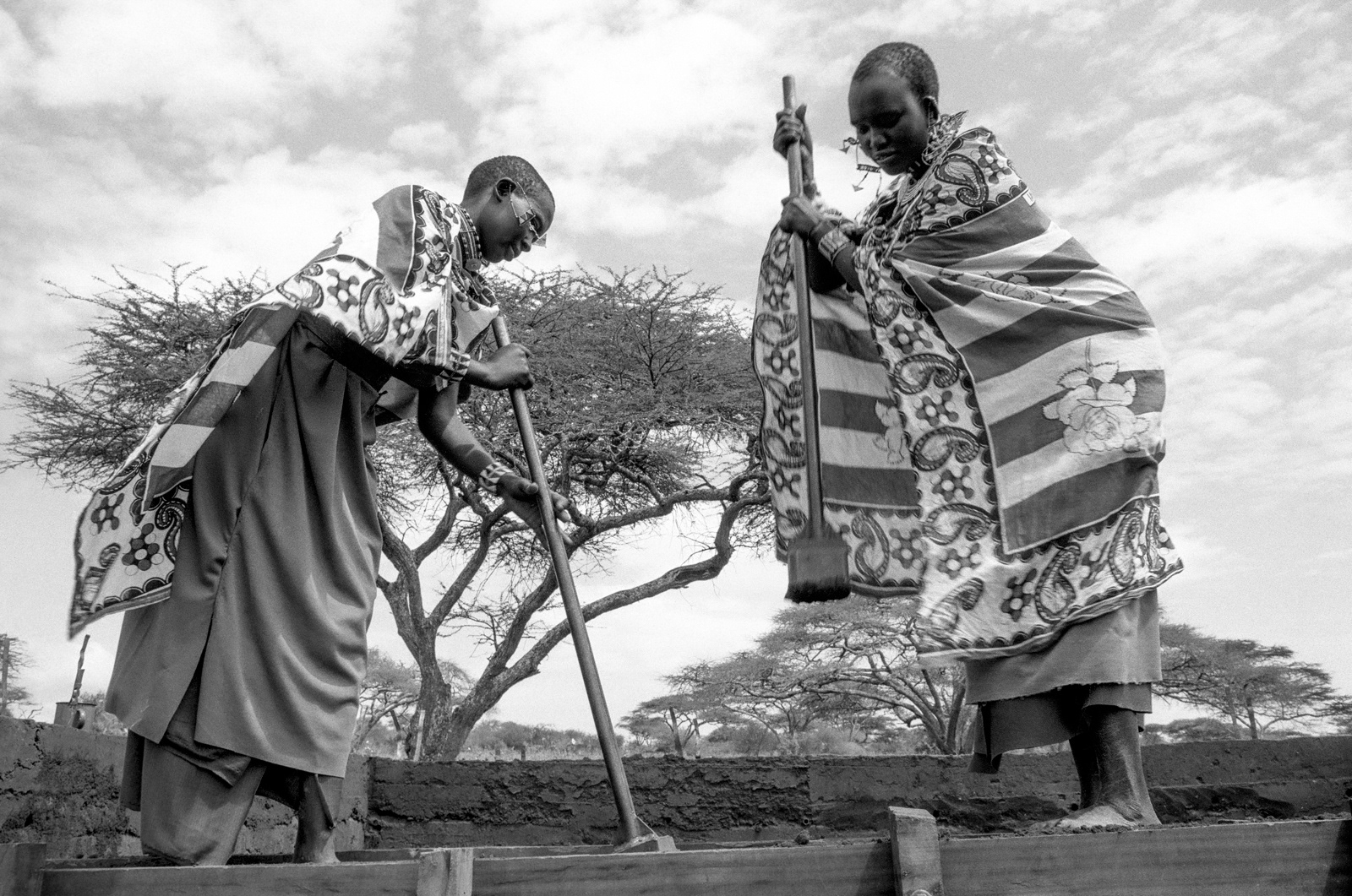 Masaai women making rammed earth house. Kadjiado, Kenya