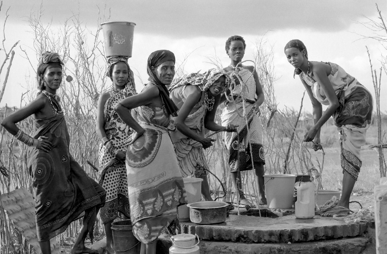Orma women drawing water at a well. Wajir, N.E. Kenya